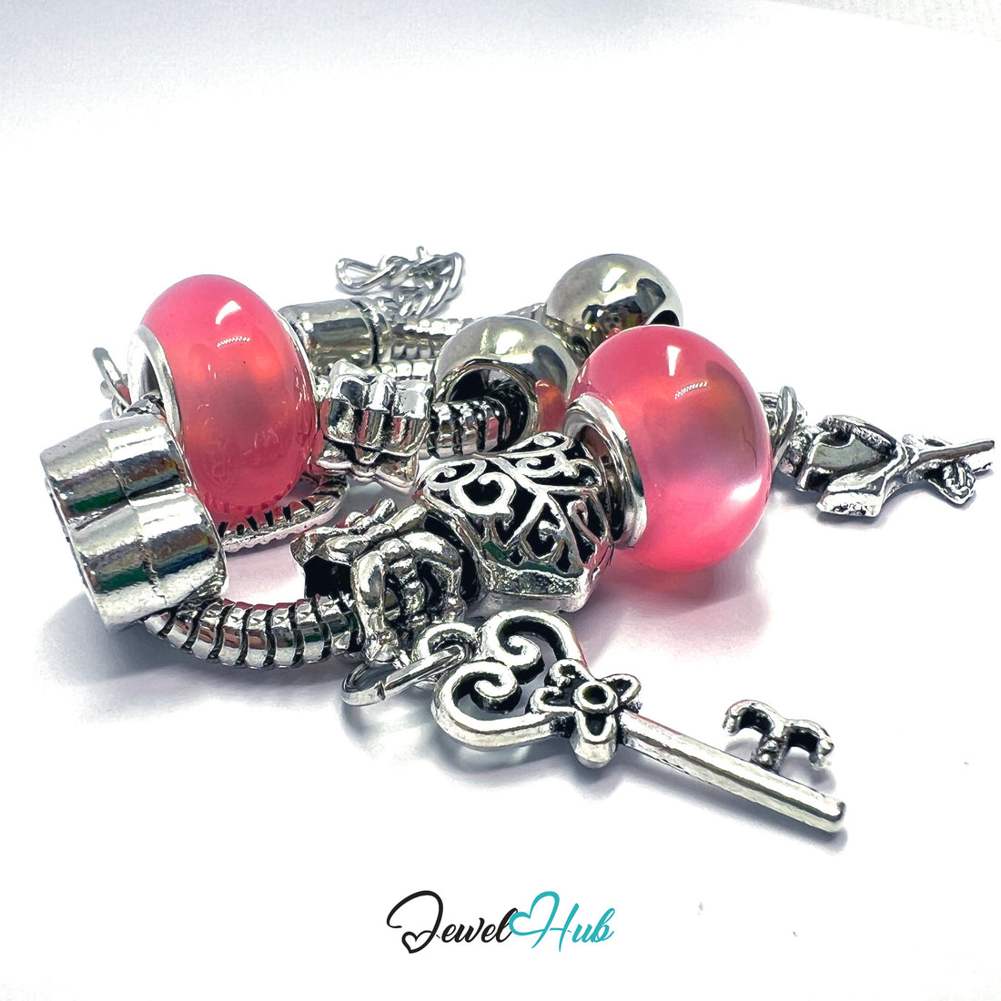 Bracelet with red beads and silver charms on a white background, branded 'Jewel Hub'.