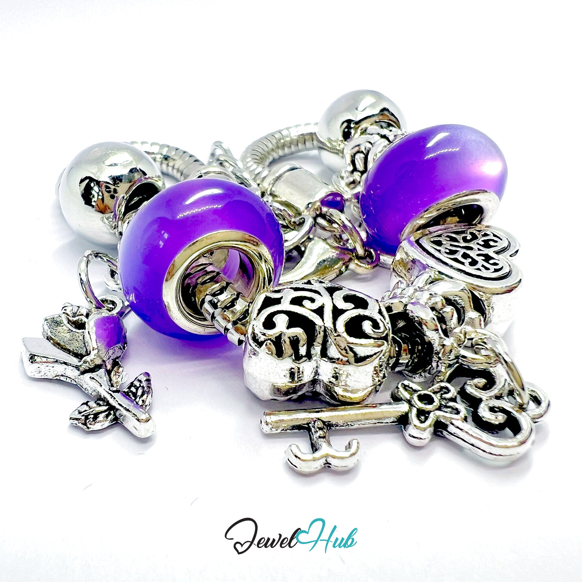 Silver and purple charm bracelet with various charms on a white background, branded 'Jewel Hub'.