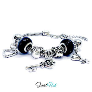 Silver charm bracelet with black beads on a white background, branded 'Jewel Hub'.