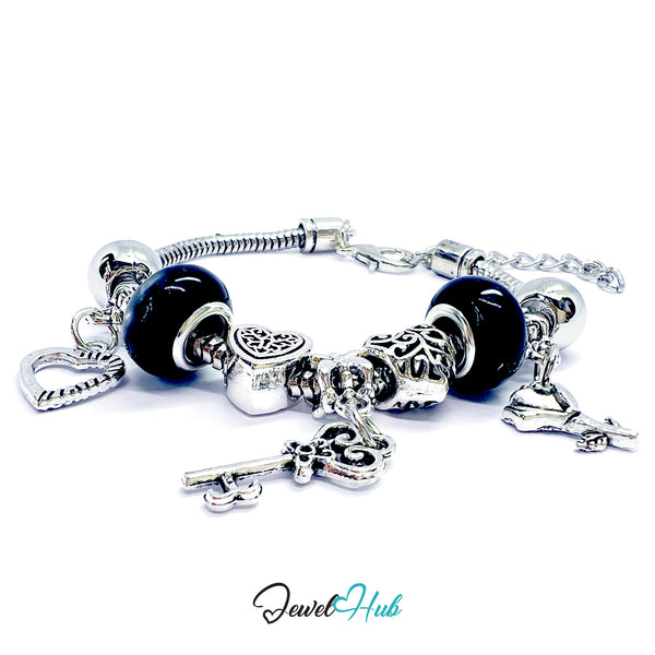Silver charm bracelet with black beads on a white background, branded 'Jewel Hub'.