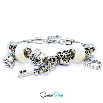 Silver bracelet with various charms on a white background, branded 'Jewel Hub'.