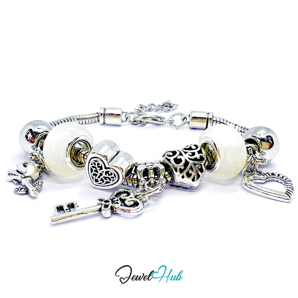 Silver bracelet with various charms on a white background, branded 'Jewel Hub'.