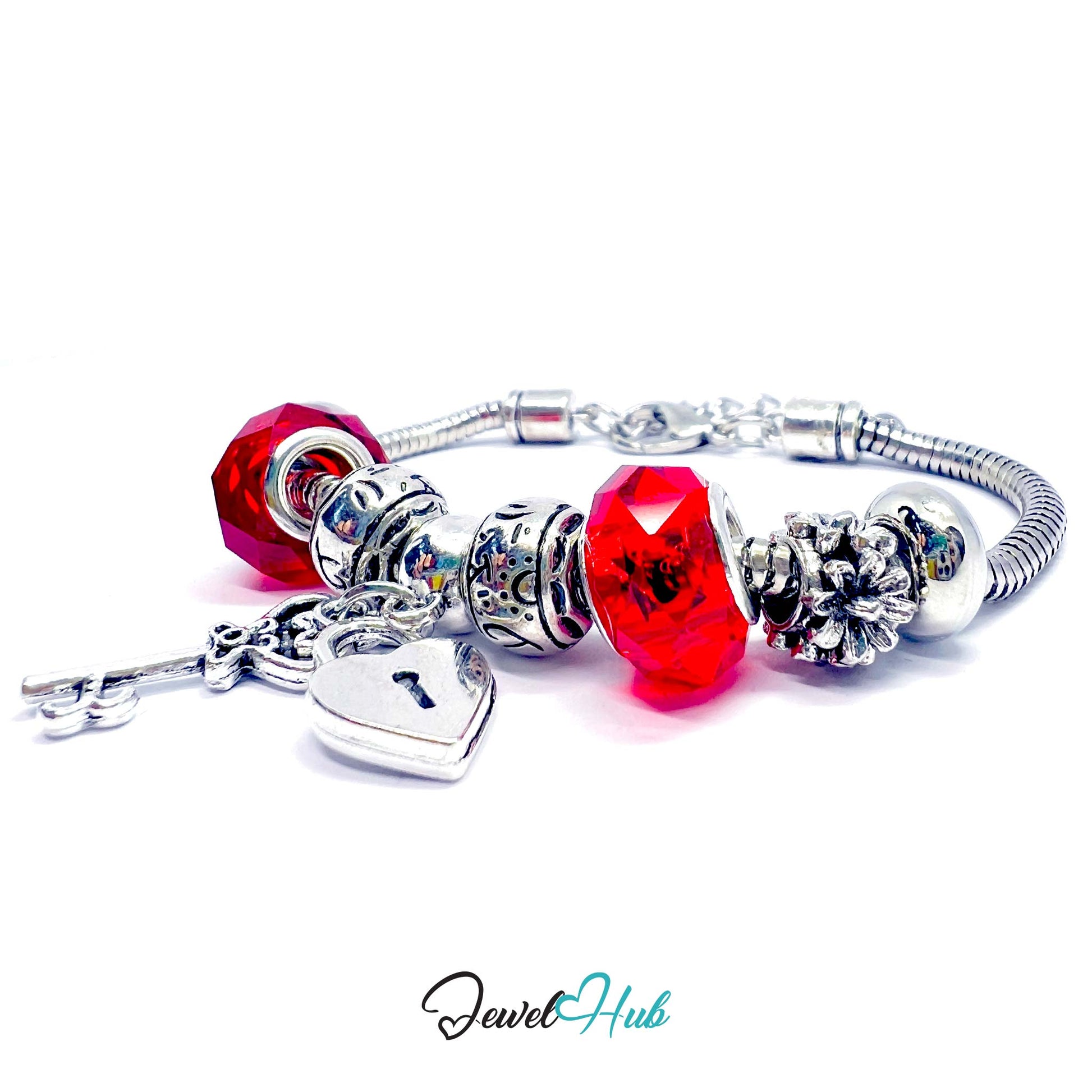 Silver bracelet with red beads and charms on a white background, branded 'Jewel Hub'.