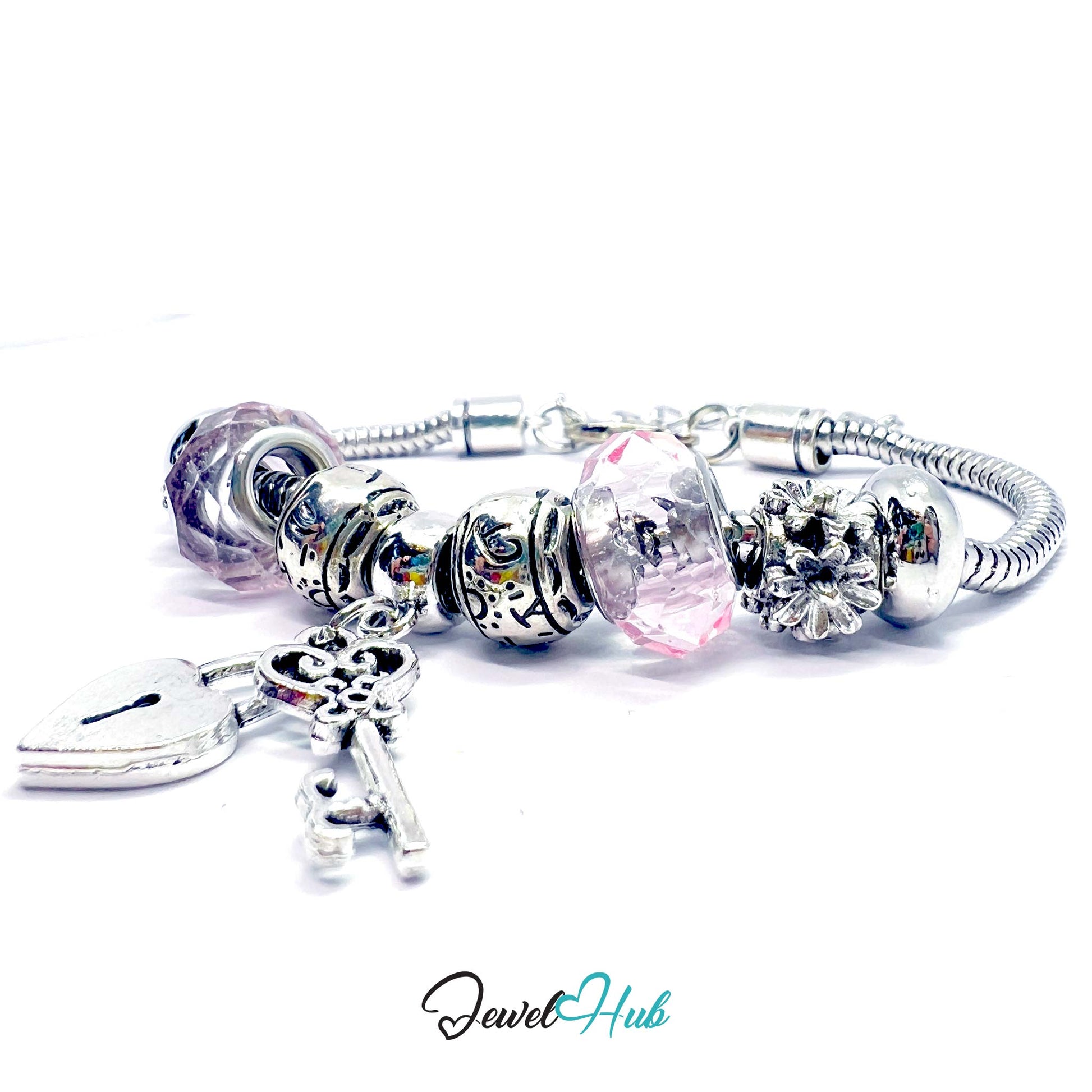Silver bracelet with various charms on a white background, branded 'Jewel Hub'.