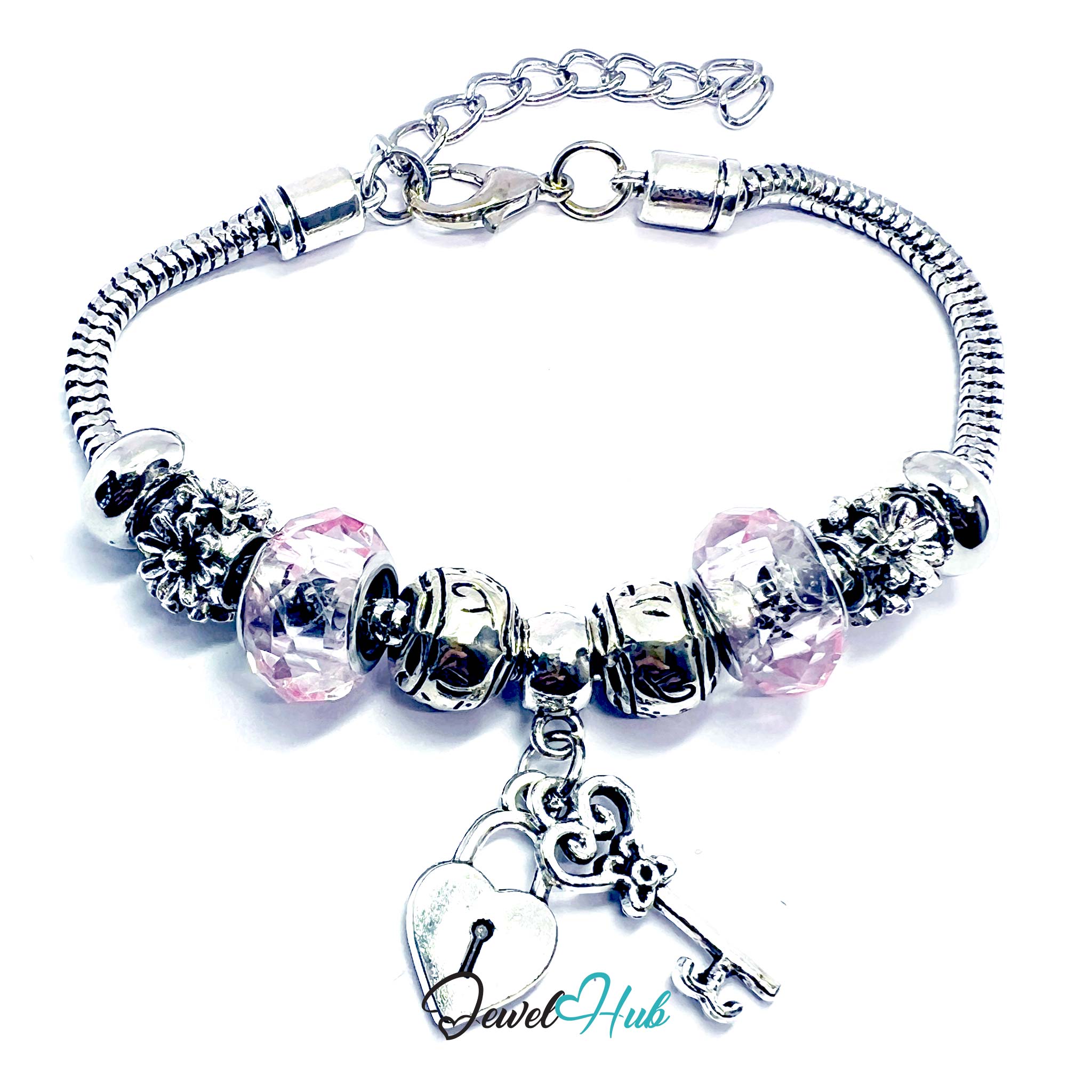 Silver bracelet with heart and key charm on a white background