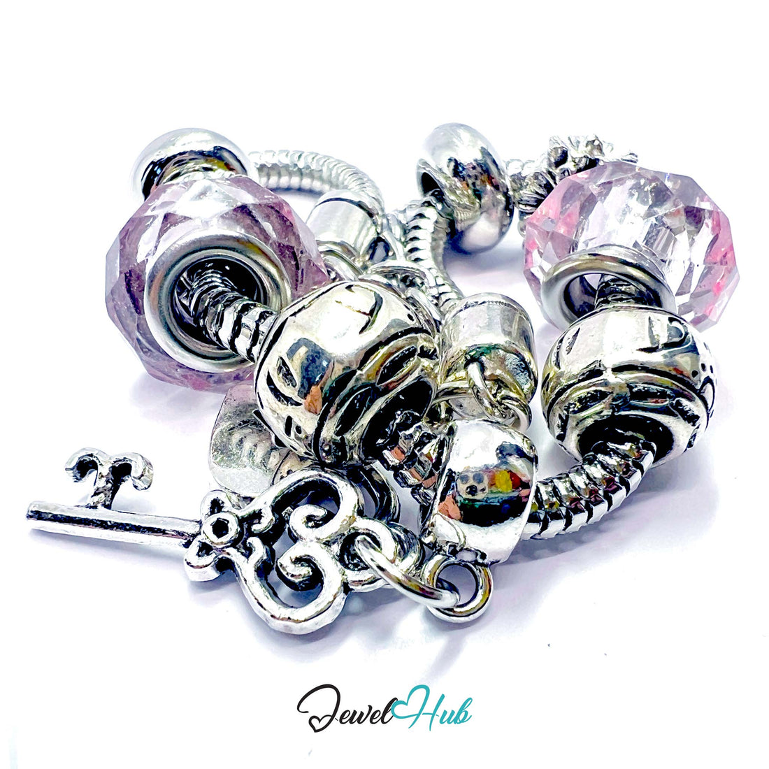 Silver bracelet with pink beads and charms on a white background, branded 'Jewel Hub'.