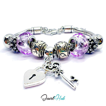 Silver bracelet with purple beads and charms on a white background, branded 'Jewel Hub'.