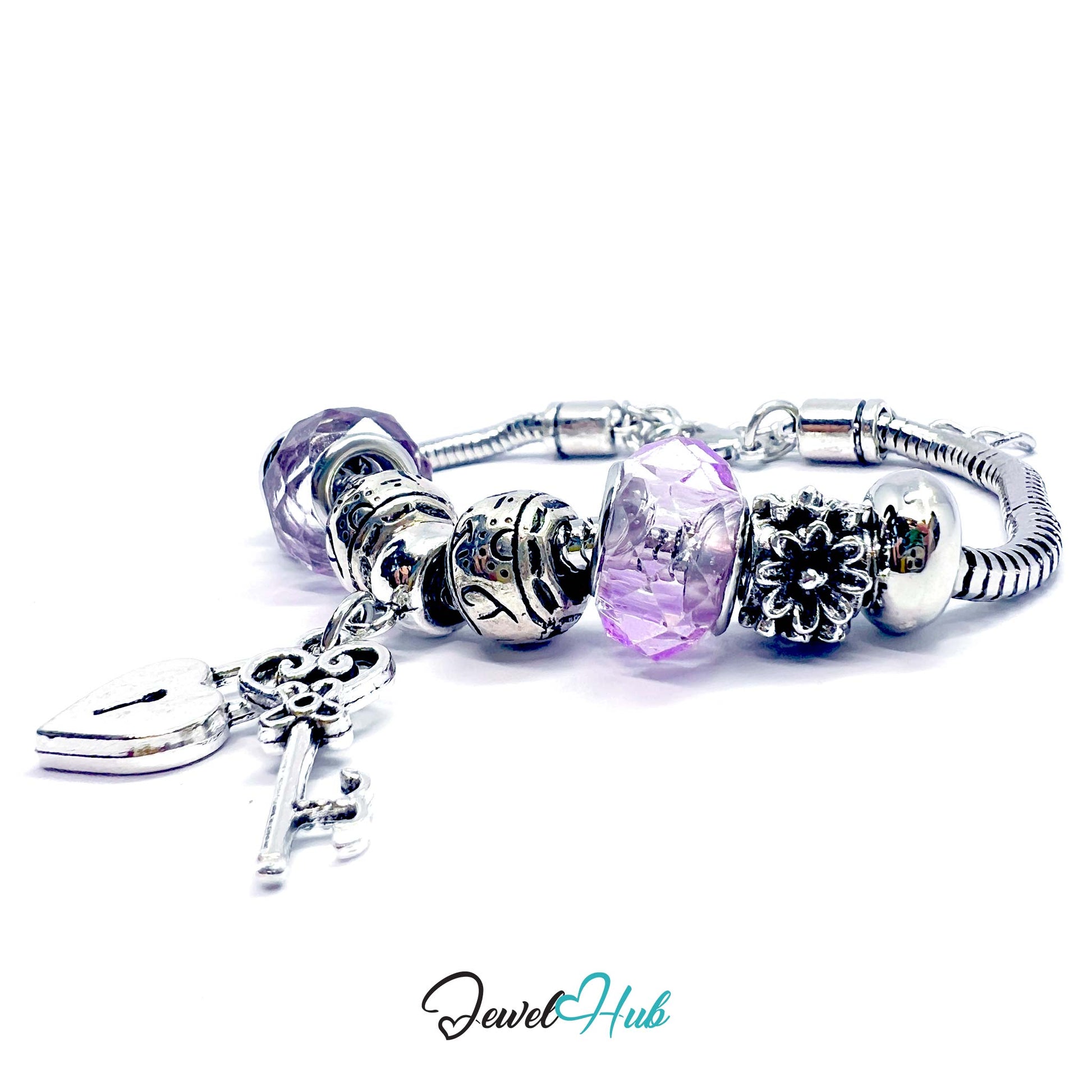 Silver bracelet with various charms on a white background, branded 'Jewel Hub'.