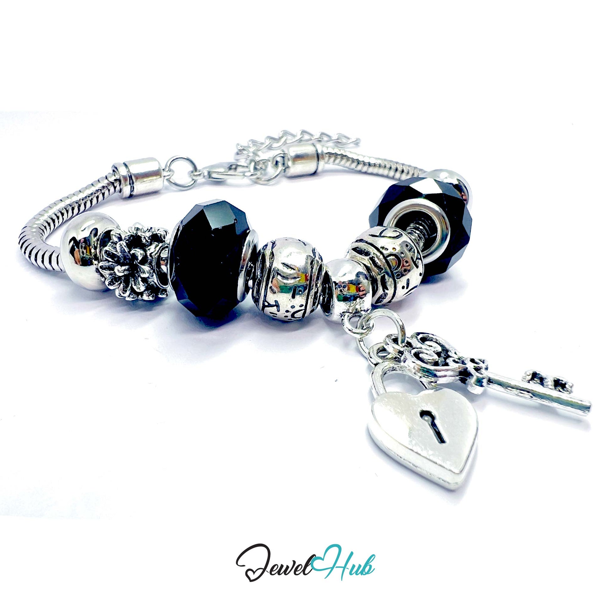 Silver bracelet with black beads and heart-shaped key charm on a white background, branded 'Jewel Hub'.
