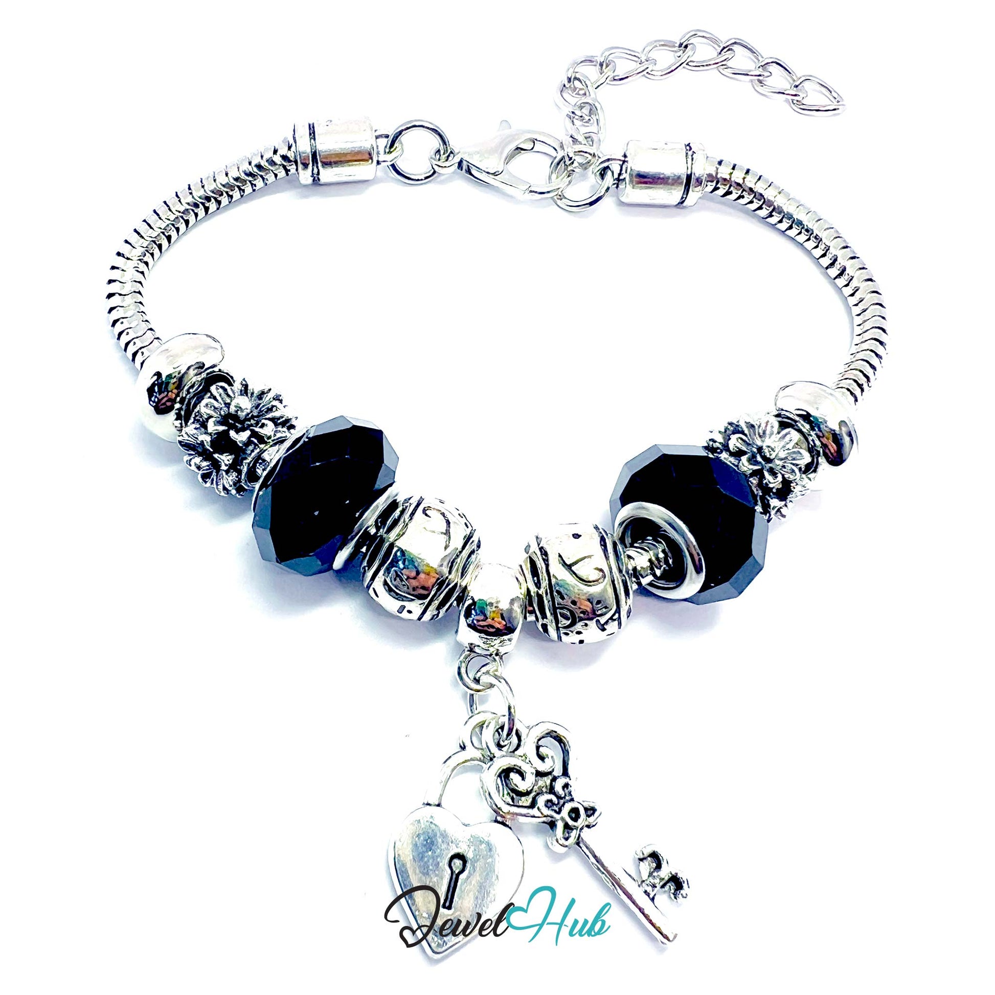 Silver bracelet with black beads and charms on a white background