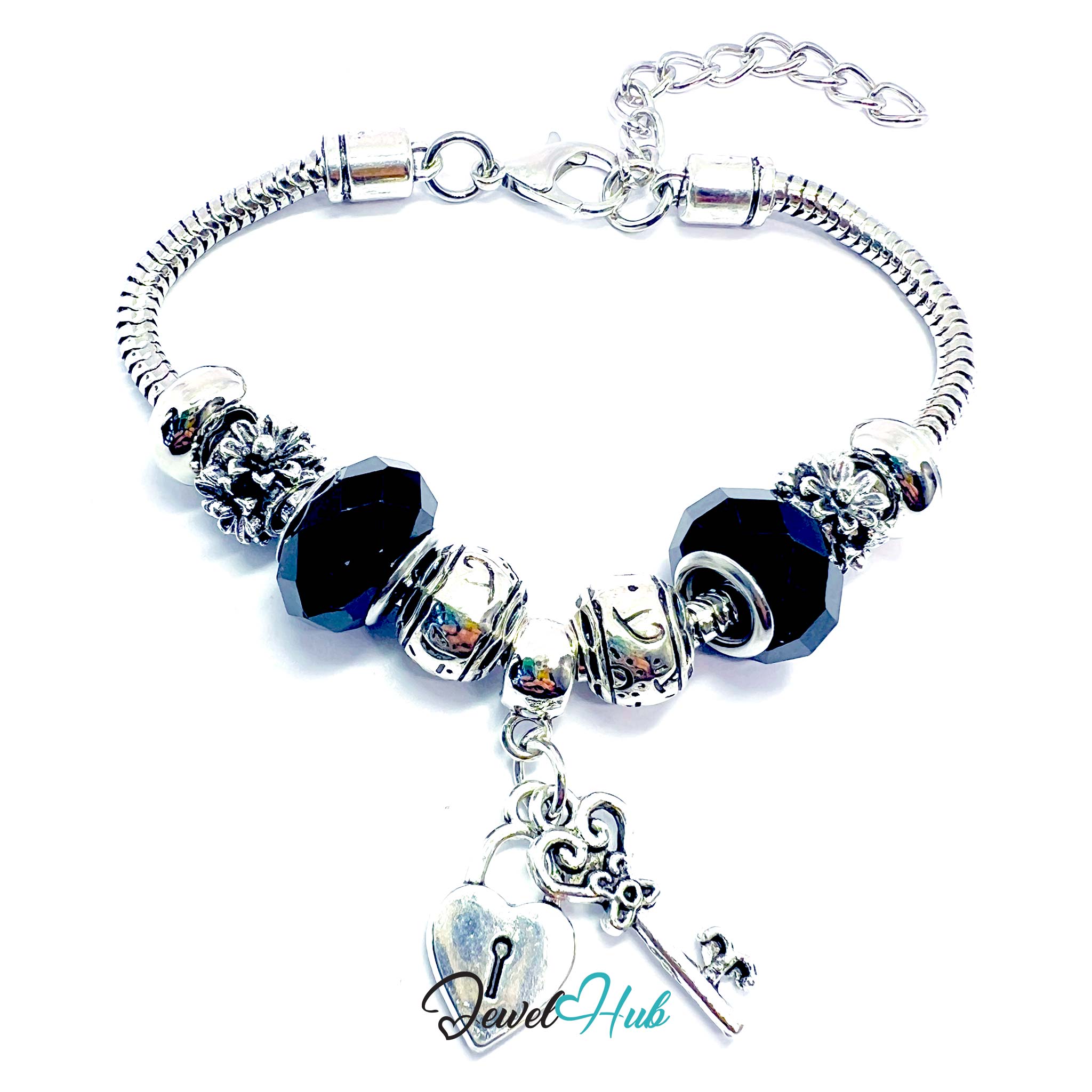 Silver bracelet with black beads and charms on a white background