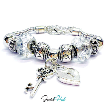 Silver charm bracelet with heart and key charms on a white background, branded 'Jewel Hub'.