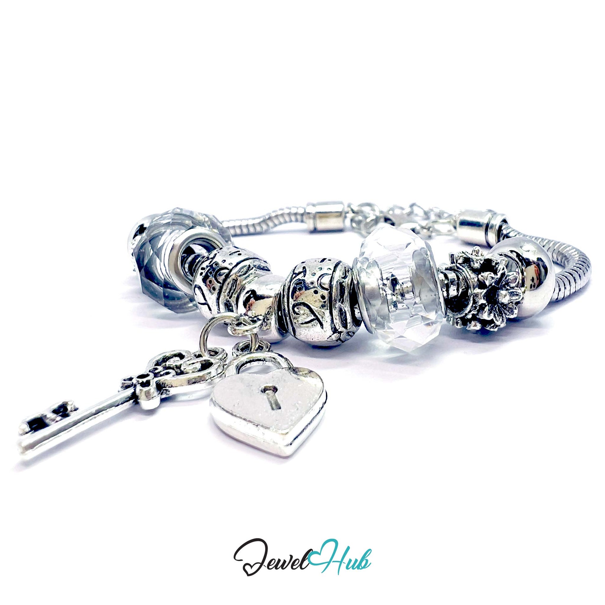 Silver charm bracelet with heart-shaped lock charm on a white background, branded 'Jewel Hub'.