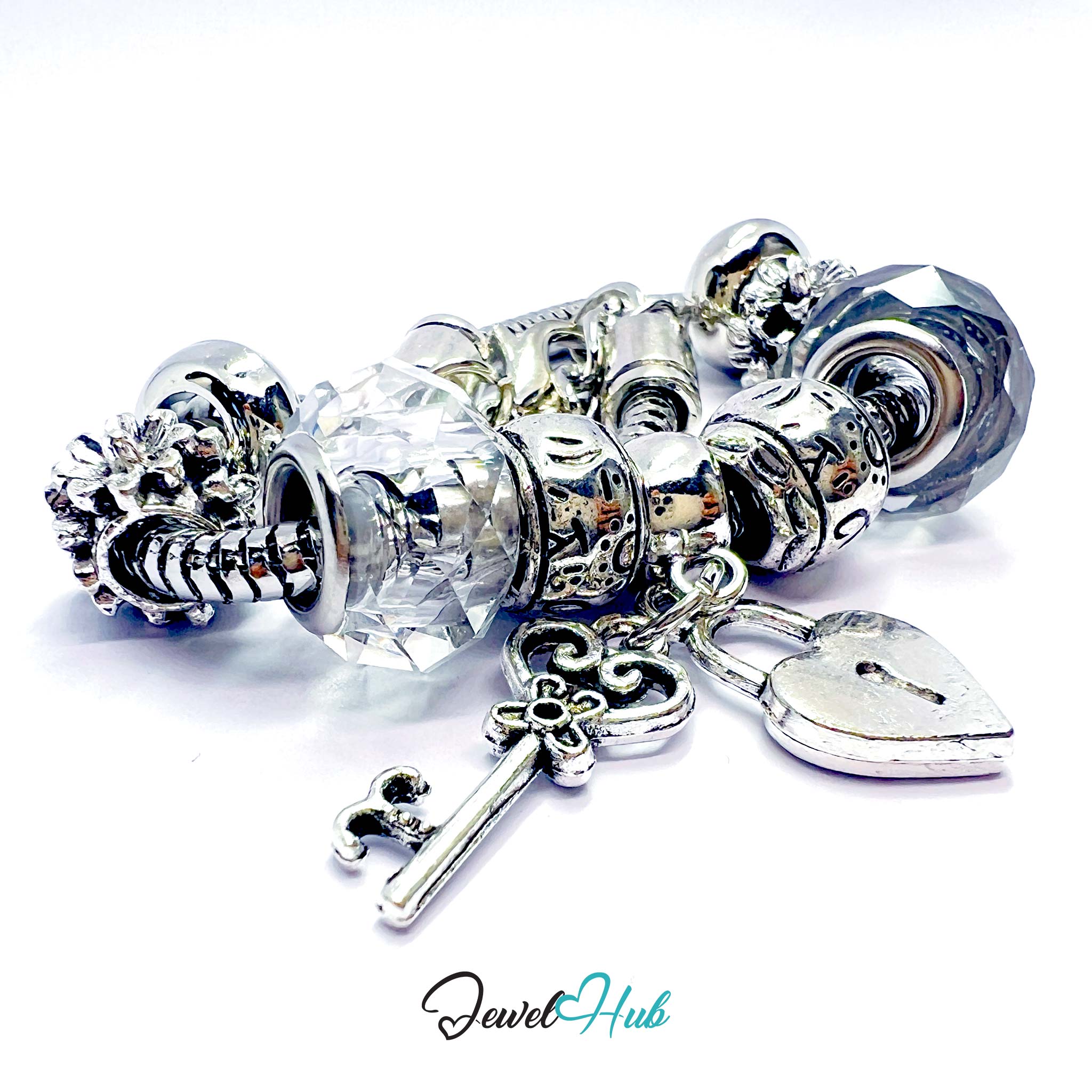 Silver charm bracelet with various charms on a white background, featuring the brand 'Jewel Hub'.