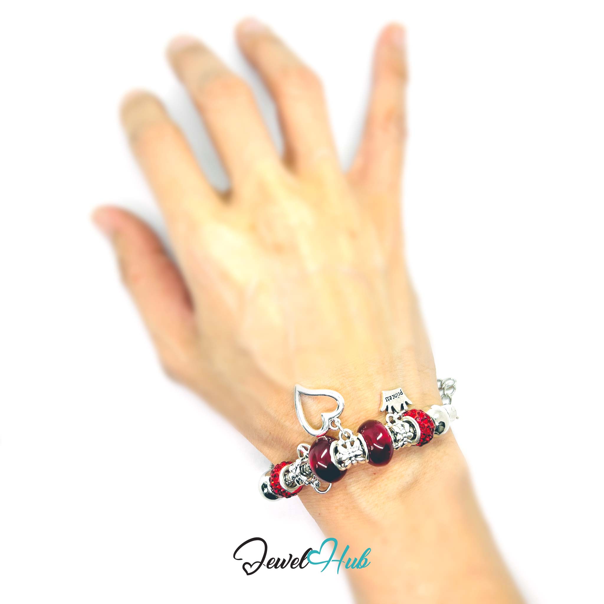 Bracelet with red and silver charms on a wrist against a white background, brand 'Jewel Hub' visible.