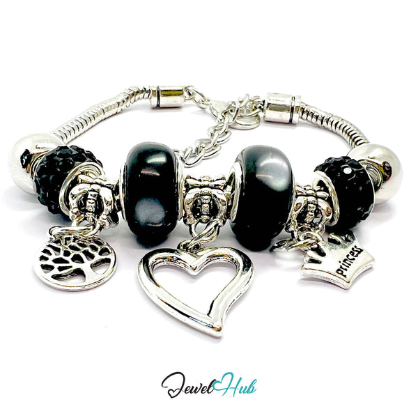 Silver bracelet with black beads and charms on a white background, branded 'Jewel Hub'.