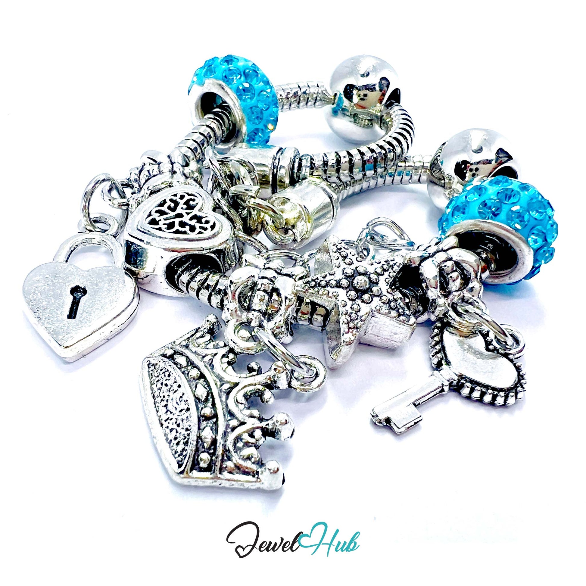 Silver charm bracelet with various charms including a heart, lock, and starfish on a white background. Brand 'Jewel Hub' visible.