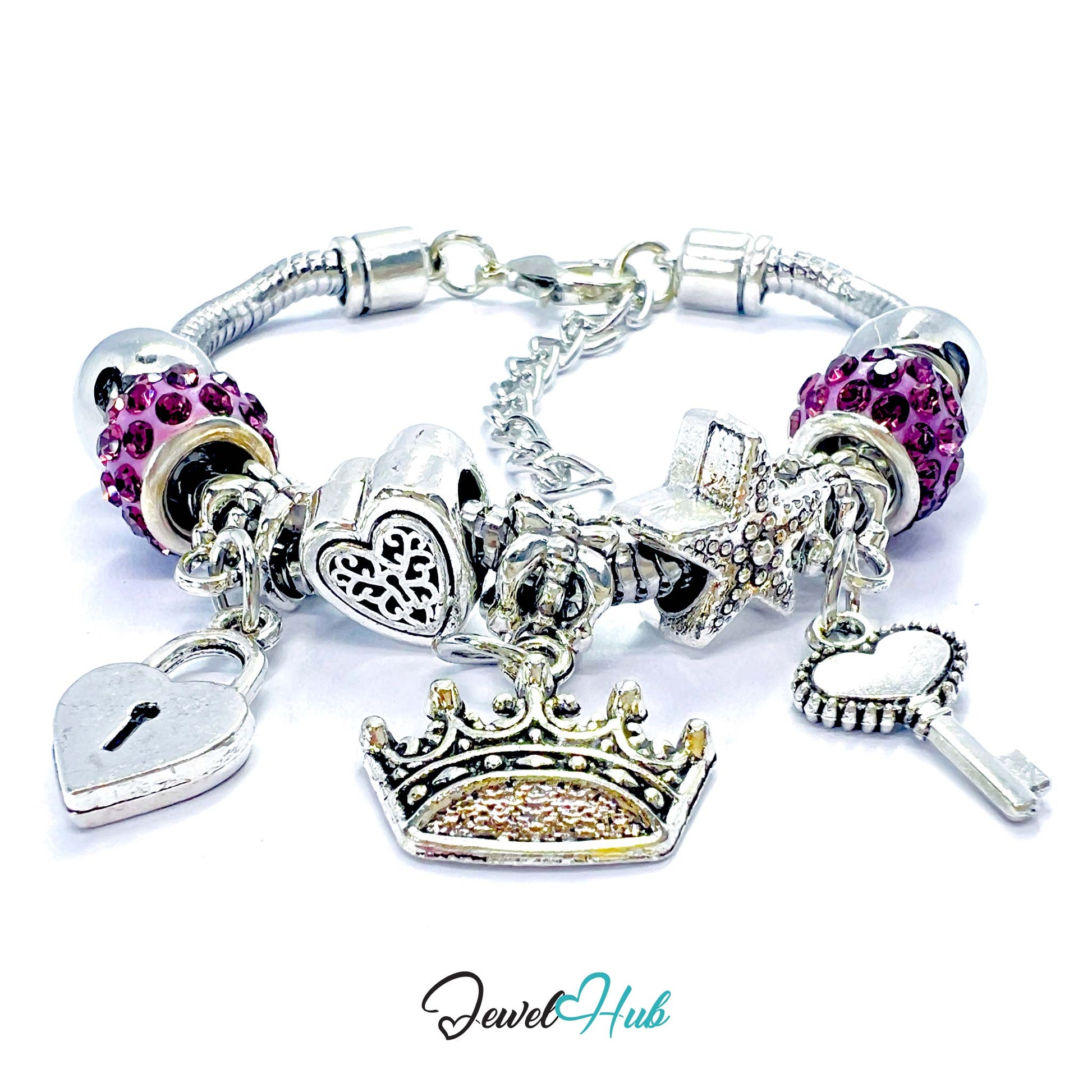 Silver charm bracelet with various charms including a crown, heart, and key on a white background. Brand 'Jewel Hub' visible.