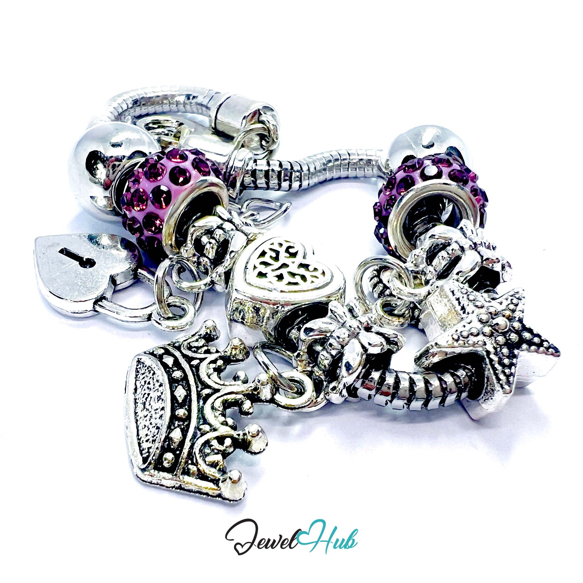 Silver charm bracelet with various charms including purple beads and starfish on a white background.