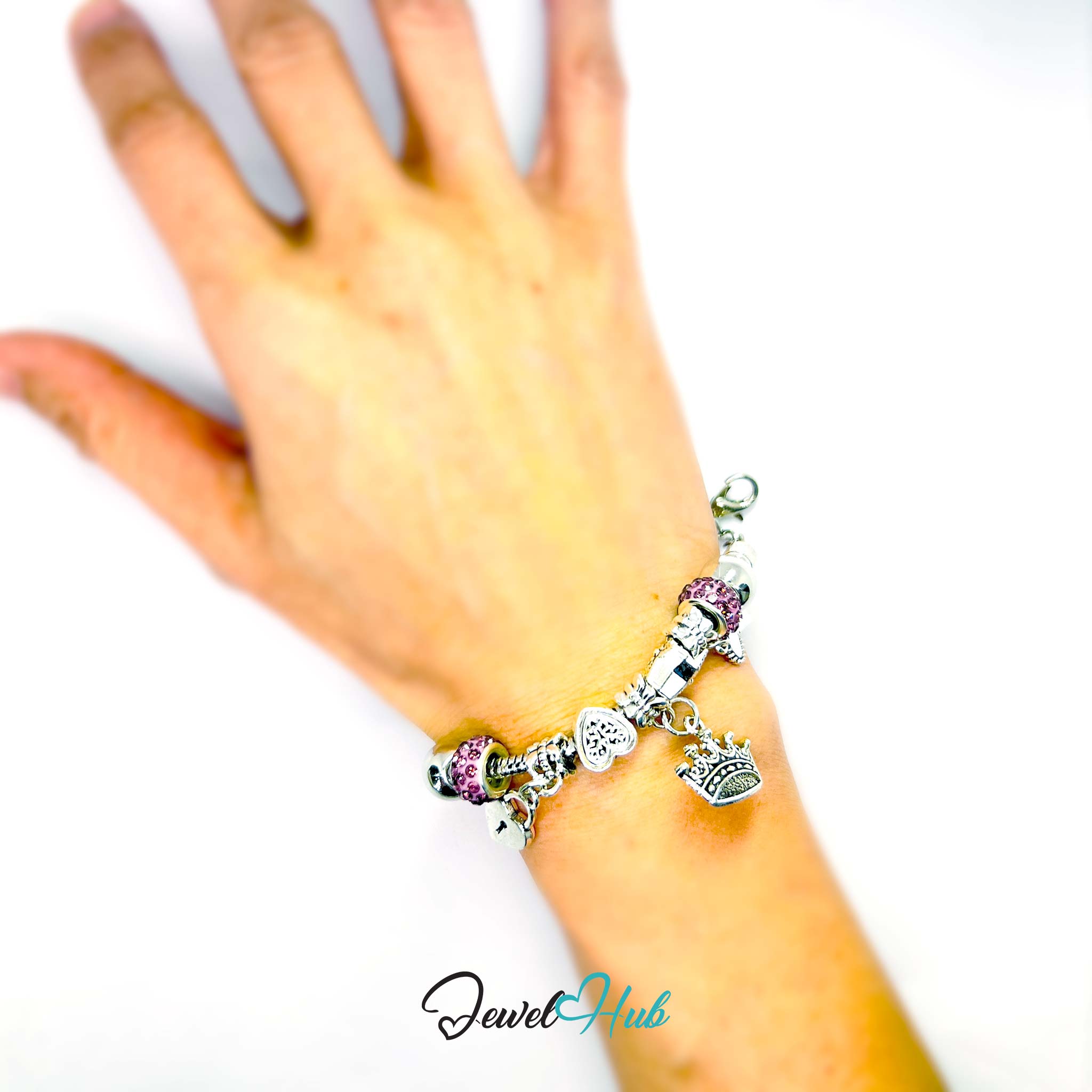 Silver bracelet with charms on a wrist against a white background, branded 'Jewel Hub'.