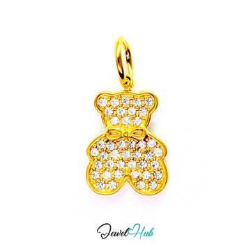 A gold bear-shaped pendant encrusted with clear pavé stones, featuring a bow detail on the chest and a top loop, shown on a white background with a JewelHub watermark.