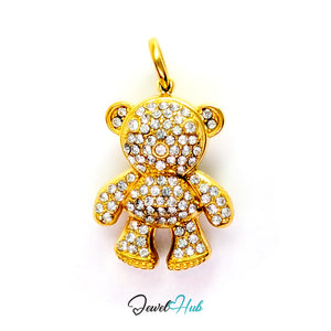 A gold teddy bear pendant encrusted with clear rhinestones, shown against a plain white background with a 'JewelHub' watermark at the bottom.