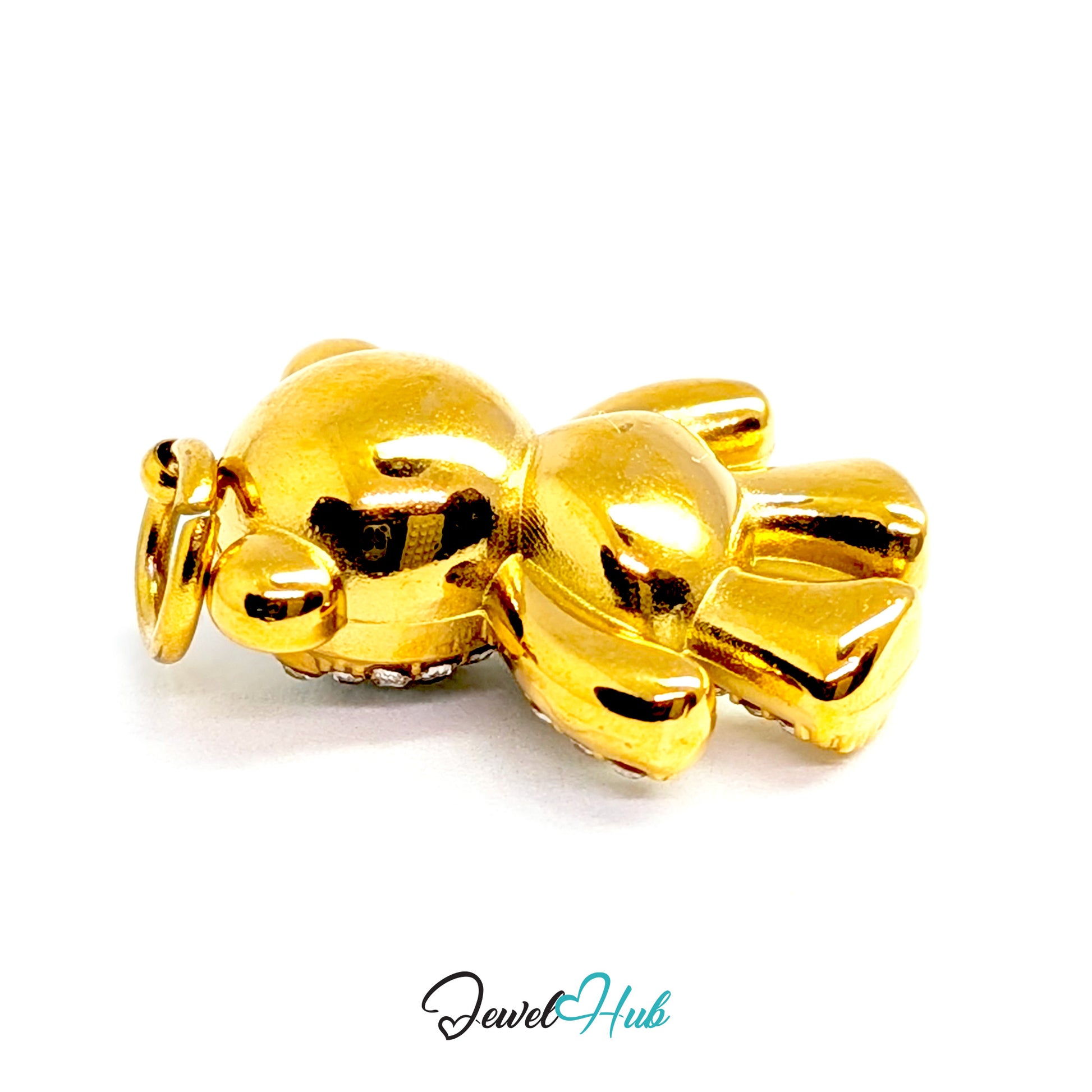 A shiny gold teddy bear charm with a small ring loop at the top, shown on a plain white background with a 'JewelHub' watermark at the bottom.
