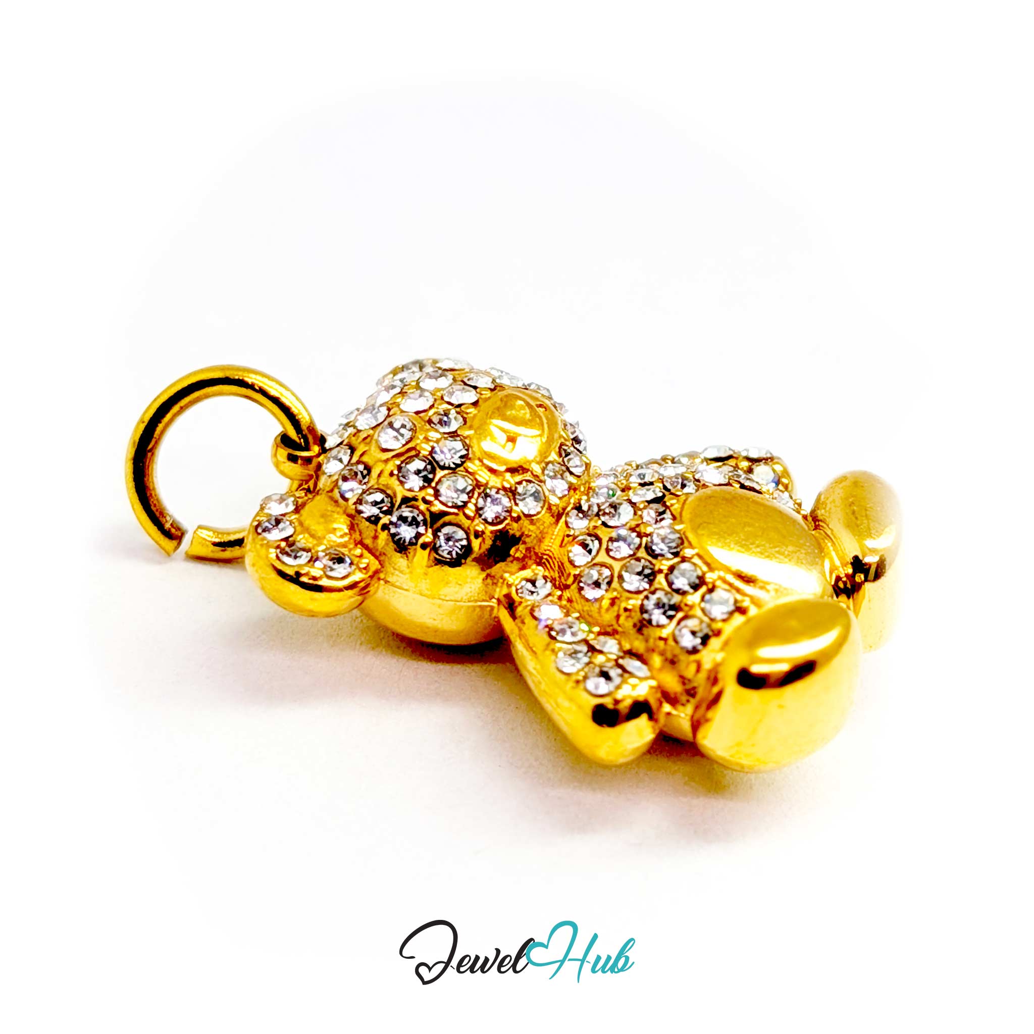 A gold-colored teddy bear charm embellished with clear rhinestones, featuring a split ring at the top, shown on a white background with a 'JewelHub' watermark.