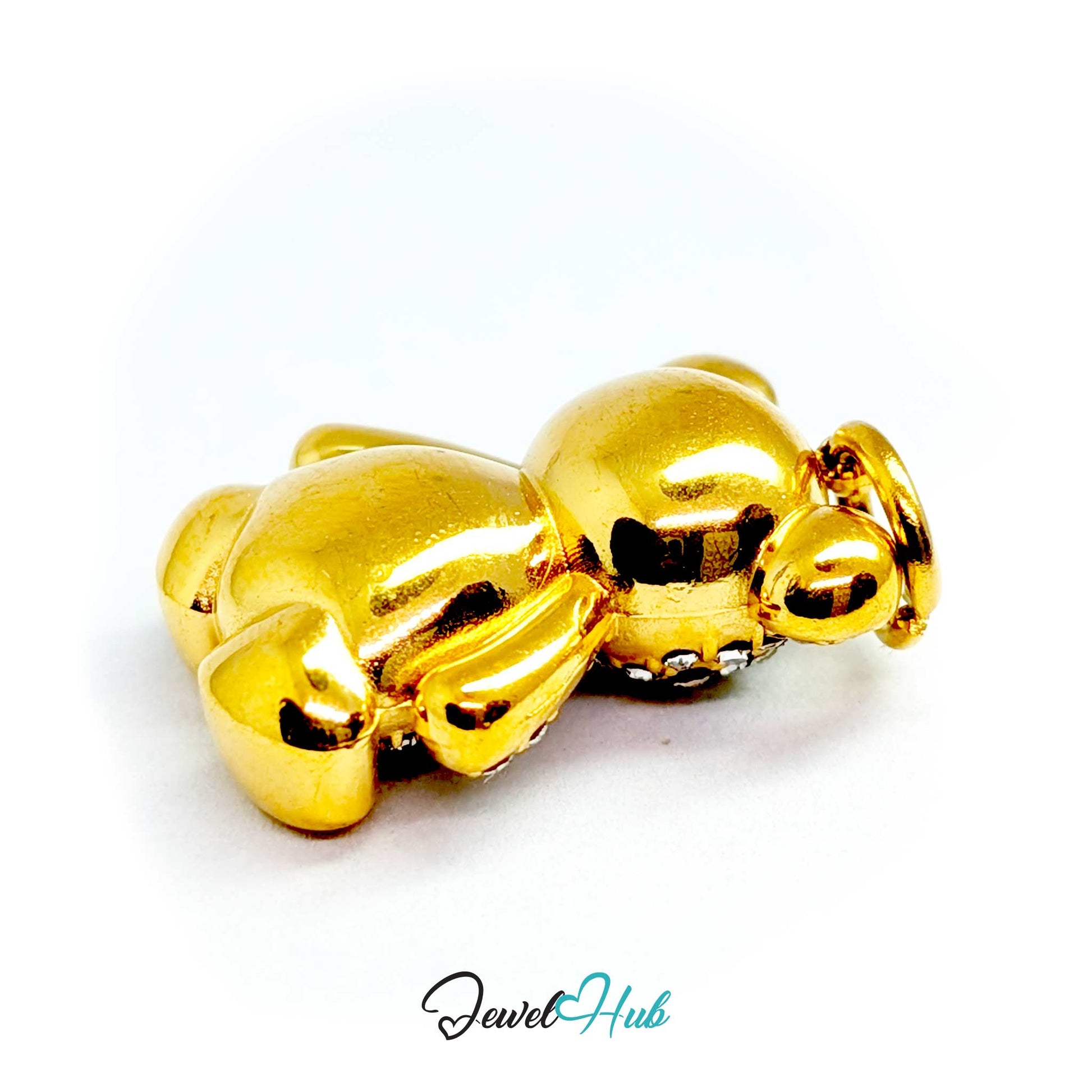 A shiny gold metallic bear-shaped charm or bead with small clear rhinestones along the front, shown on a plain white background with a JewelHub watermark at the bottom.