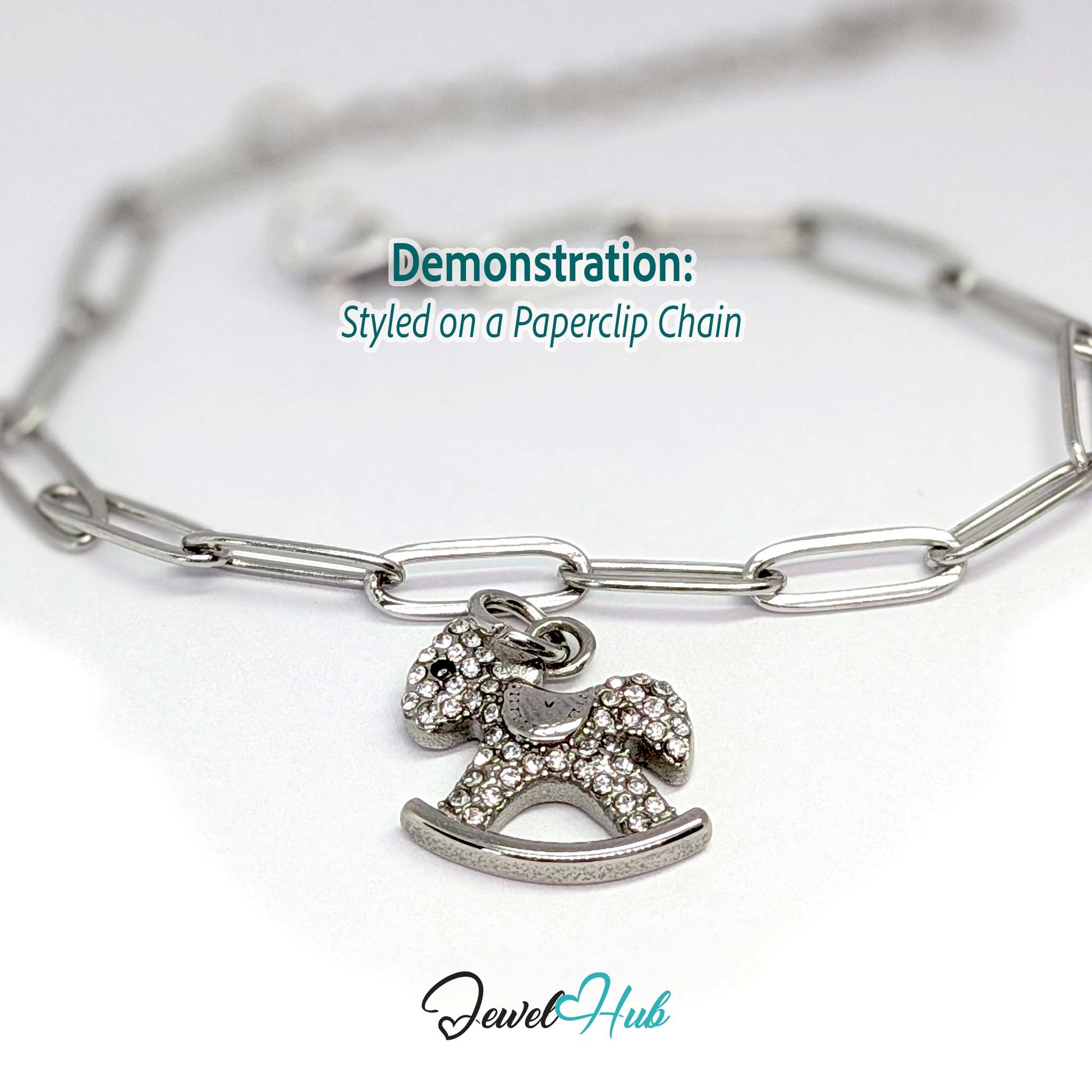 Silver rocking horse charm styled on a silver paperclip chain bracelet - JewelHub