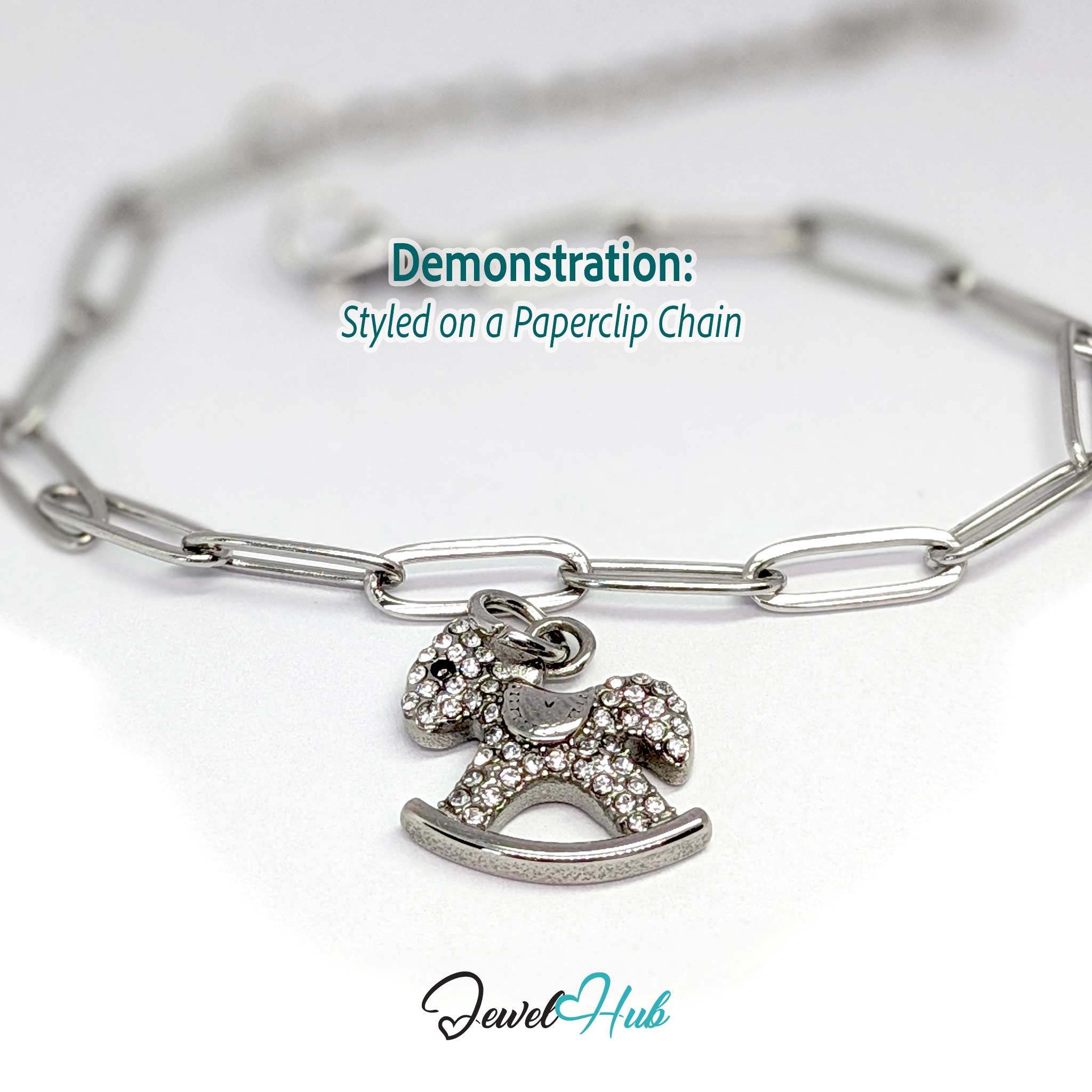 Silver rocking horse charm styled on a silver paperclip chain bracelet - JewelHub