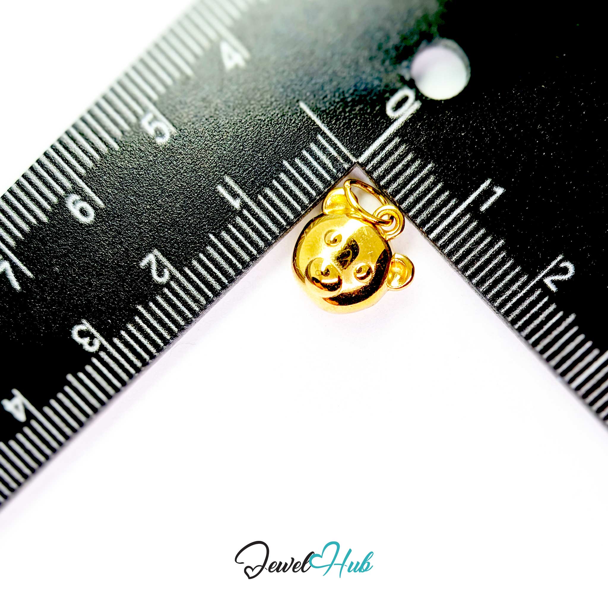 Gold bear head charm measured against a ruler at 12mm wide by 12mm tall - JewelHub