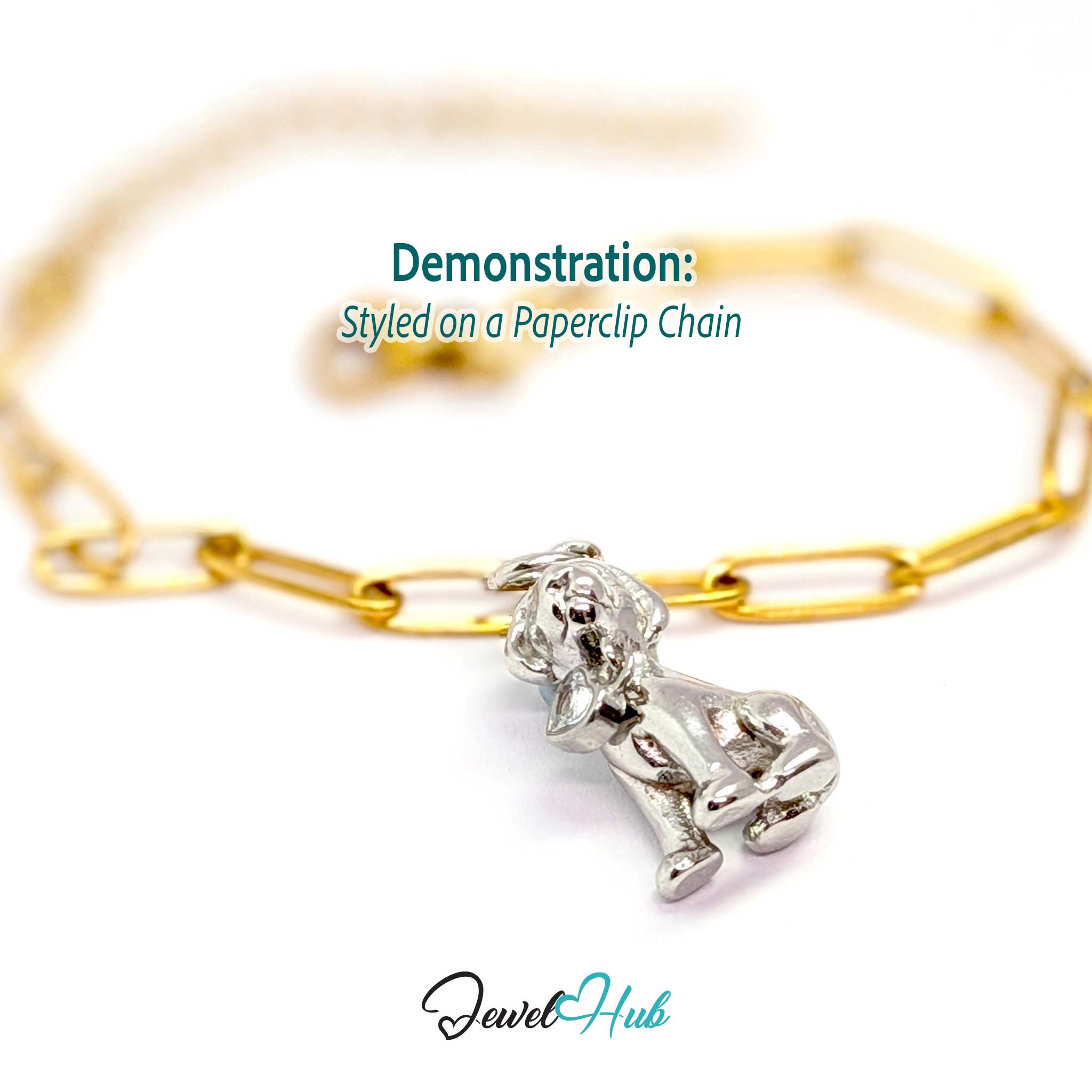 Silver sitting puppy charm styled on a gold paperclip chain bracelet for a two-tone look - JewelHub