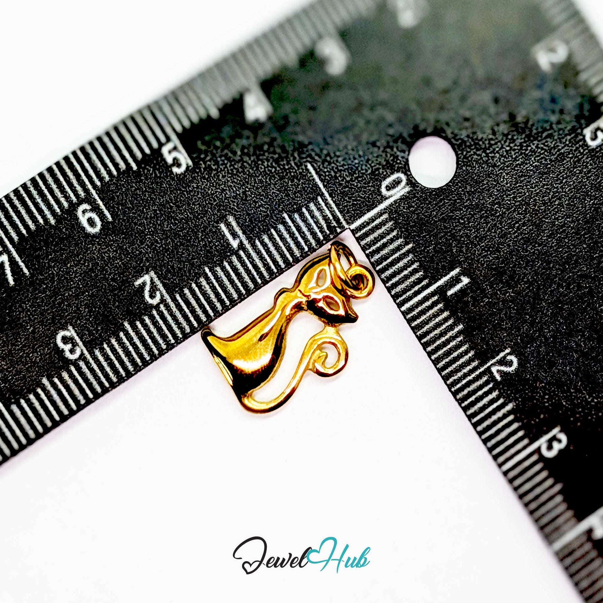 Gold standing cat charm measured against a ruler at 11.5mm wide by 19.3mm tall - JewelHub