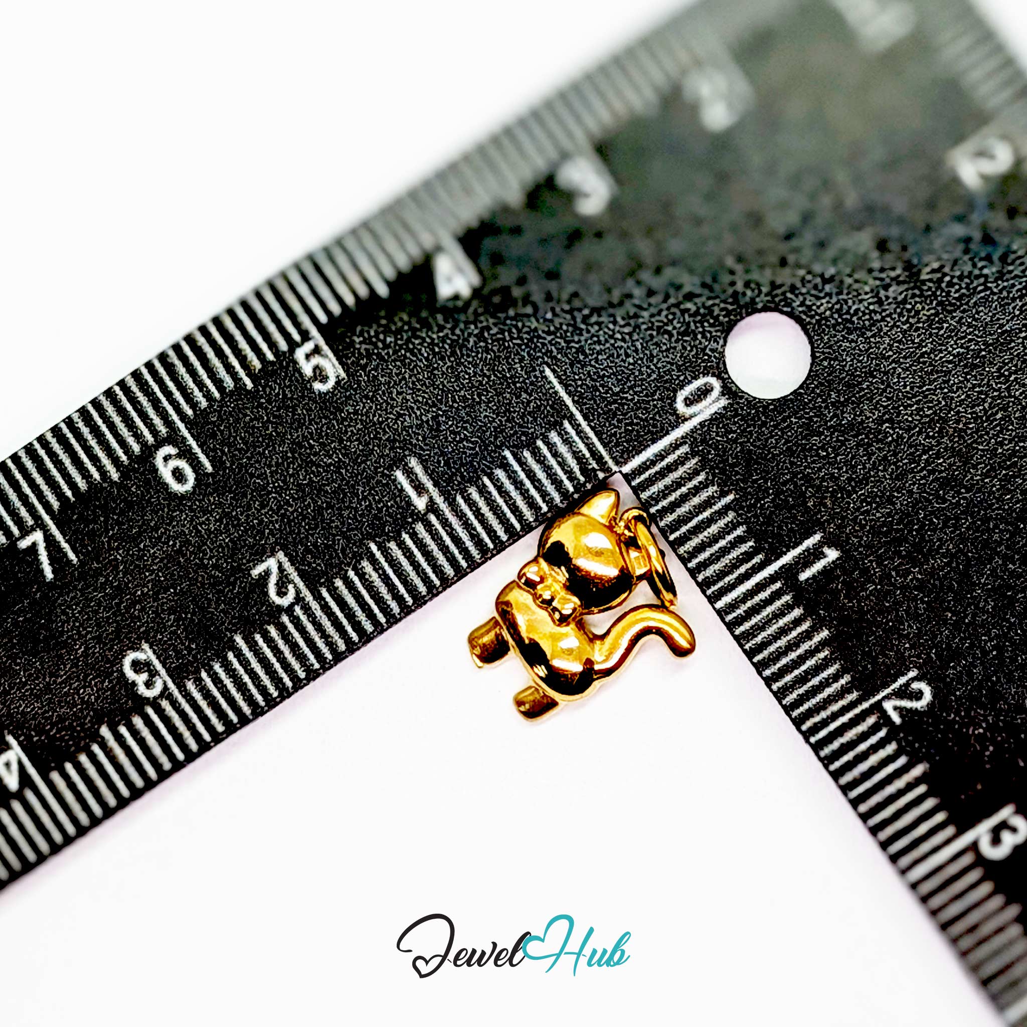 Gold cute cat charm measured against a ruler at 11.8mm wide by 15mm tall - JewelHub