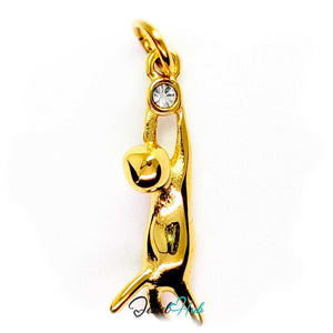 Gold cat charm hanging by its front paws from a bezel-set clear crystal - JewelHub