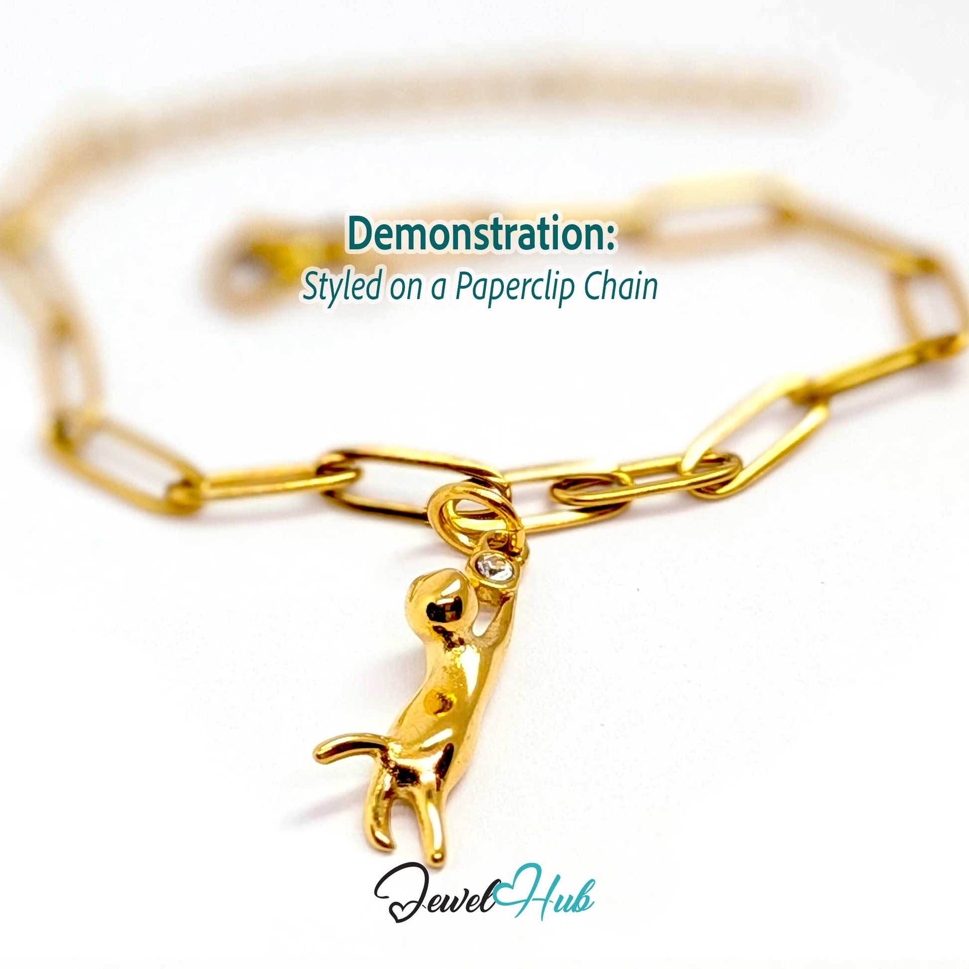 Gold hanging cat charm styled on a gold paperclip chain bracelet - JewelHub