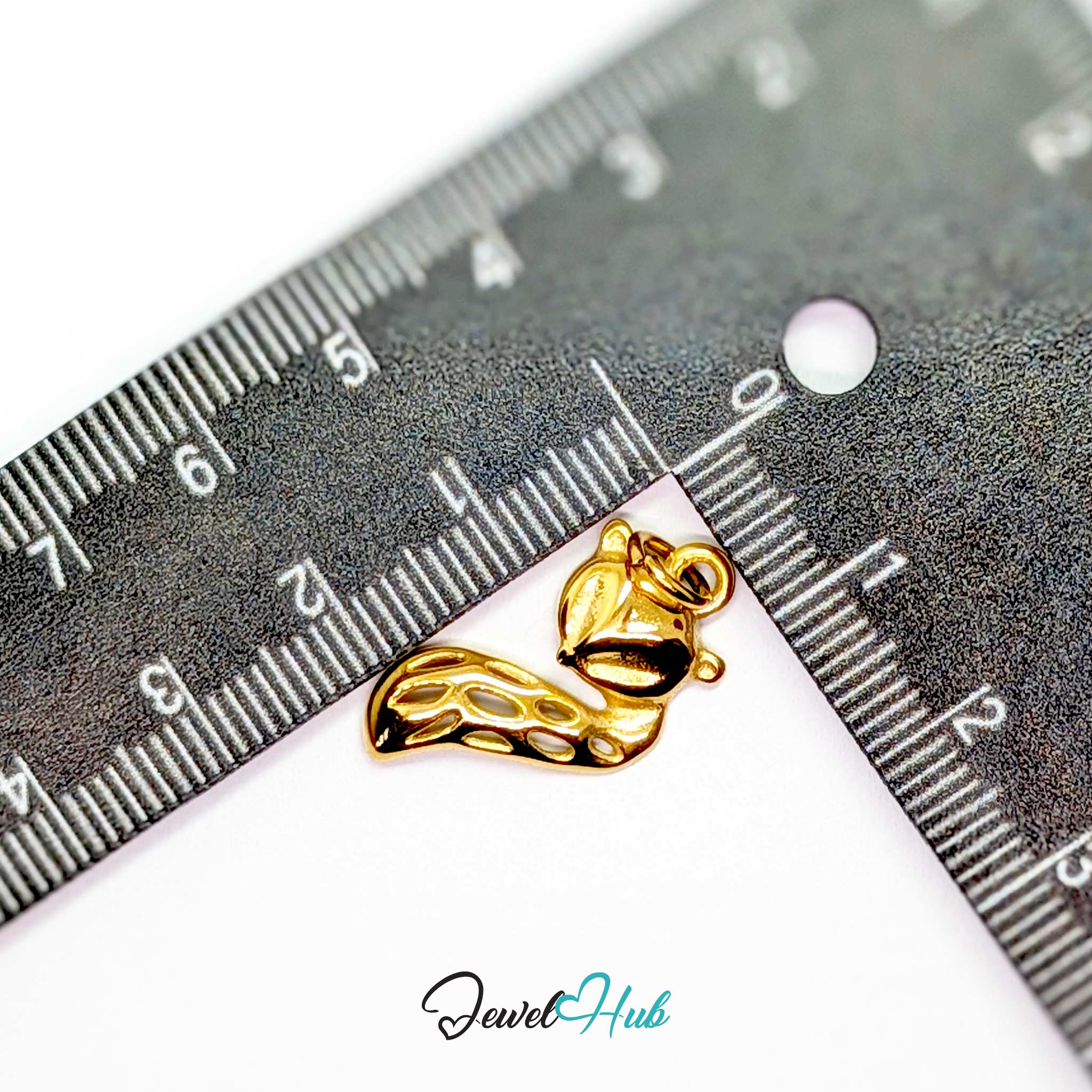Gold fox charm measured against a ruler at 13.7mm wide by 23.5mm tall - JewelHub