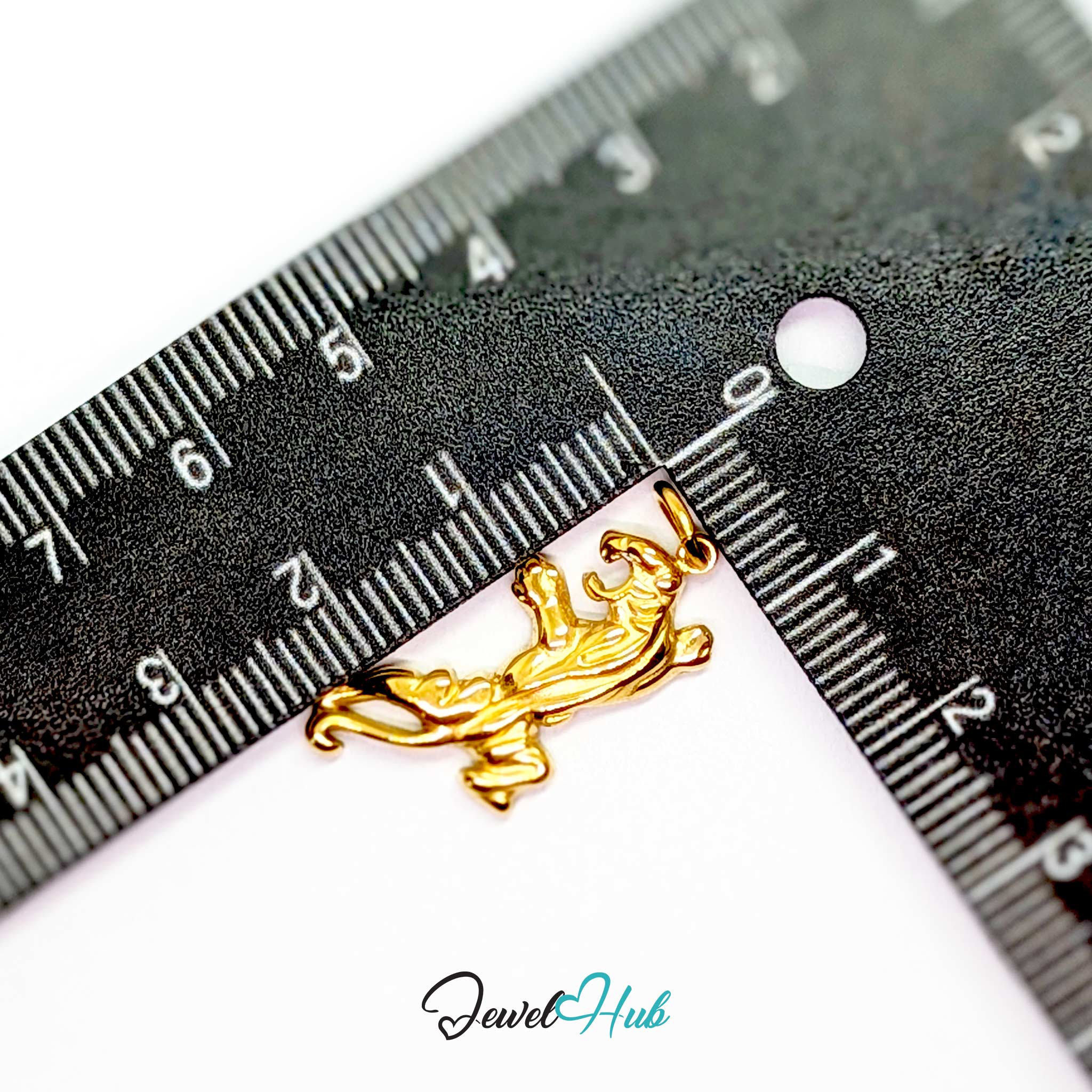 Gold tiger charm measured against a ruler at 26.3mm tall by 13mm wide - JewelHub