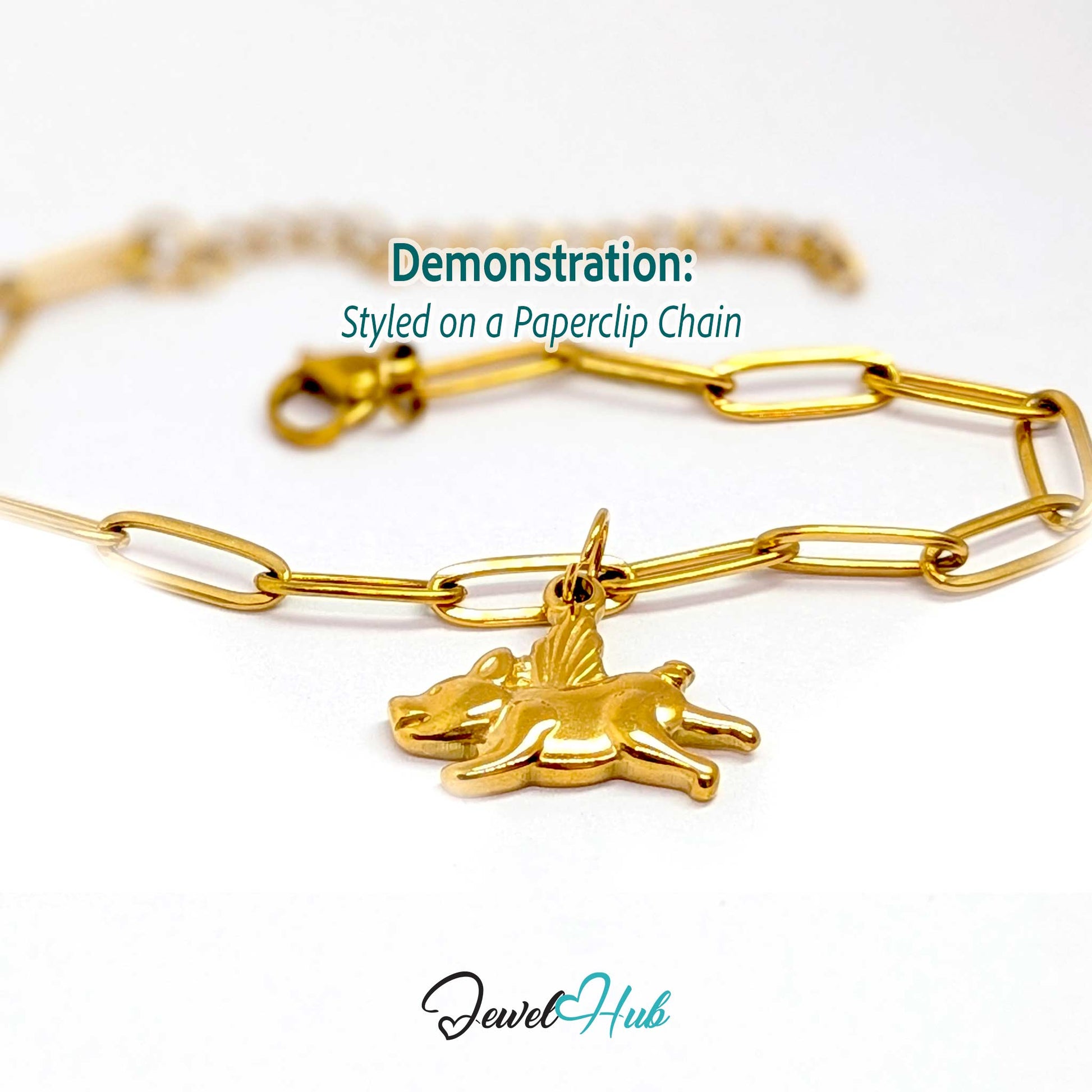 Gold flying pig charm styled on a gold paperclip chain bracelet - JewelHub