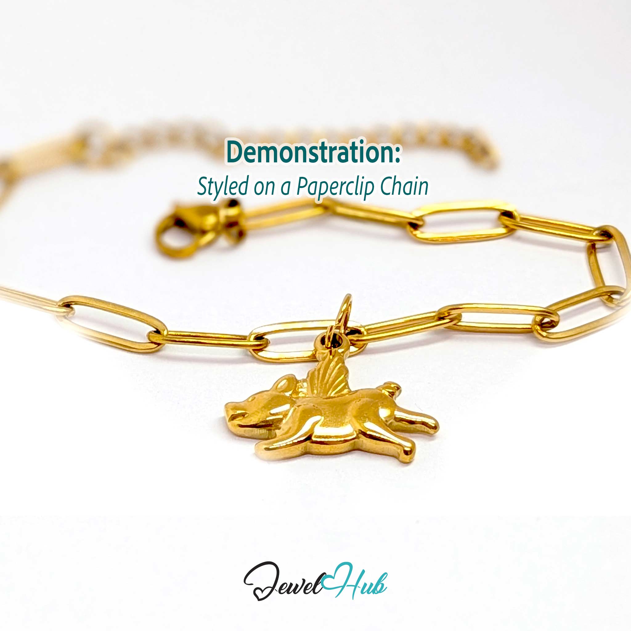 Gold flying pig charm styled on a gold paperclip chain bracelet - JewelHub