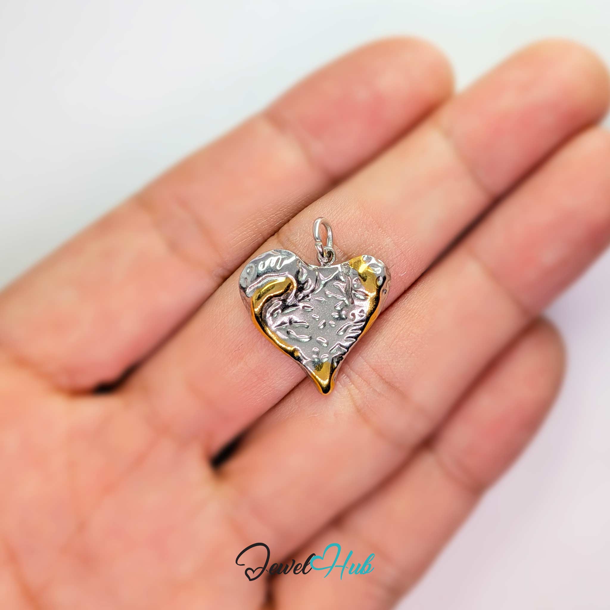 Textured Heart charm, two-tone stainless steel, held in the hand to show its size - JewelHub