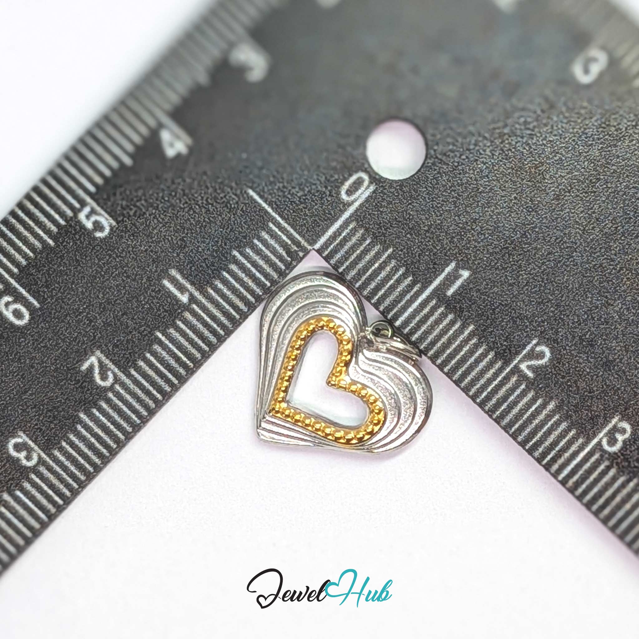 Hollow Heart charm, two-tone stainless steel, measured against a ruler at 18.3 x 15.8mm - JewelHub