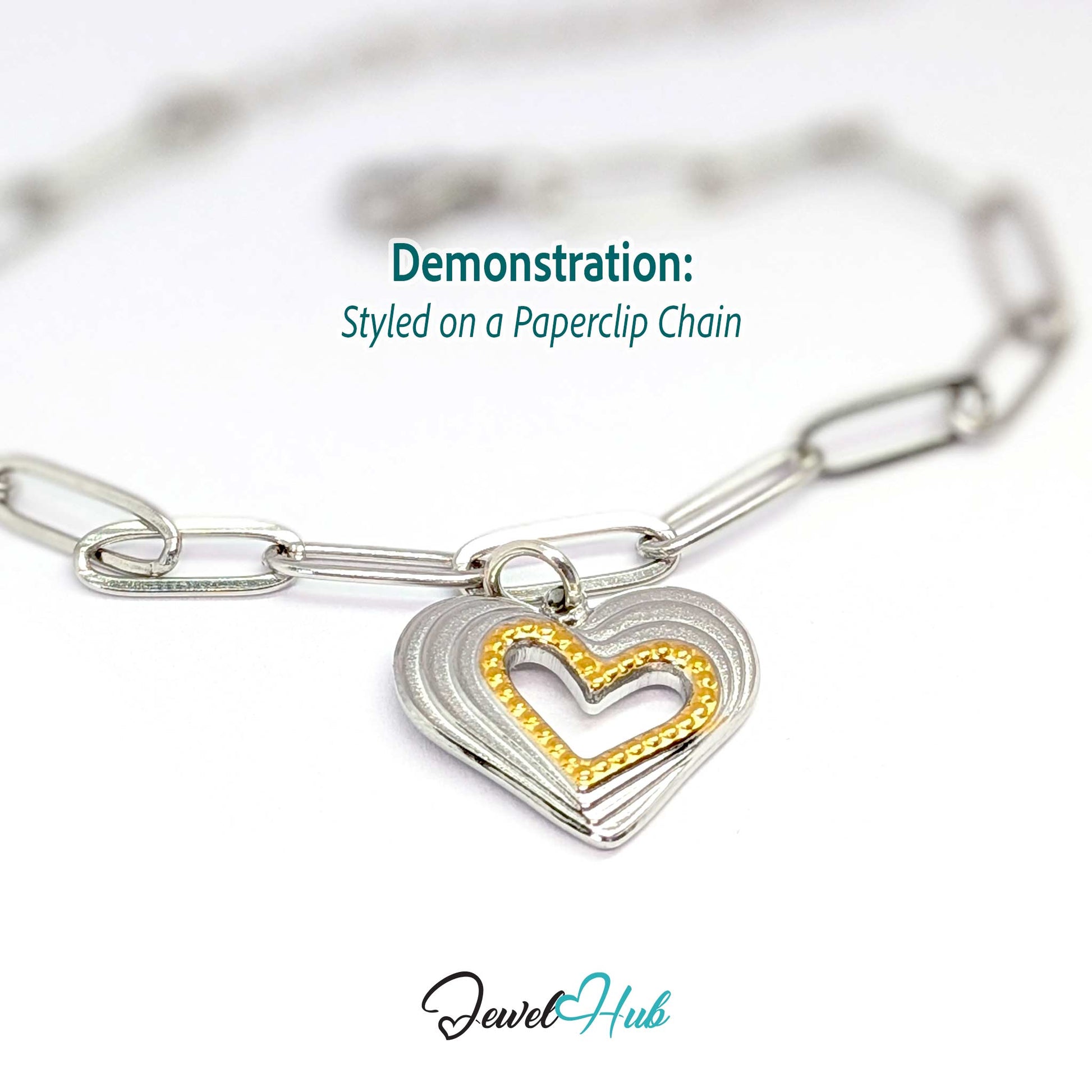 Hollow Heart charm, two-tone stainless steel, styled on a silver paperclip chain bracelet - JewelHub