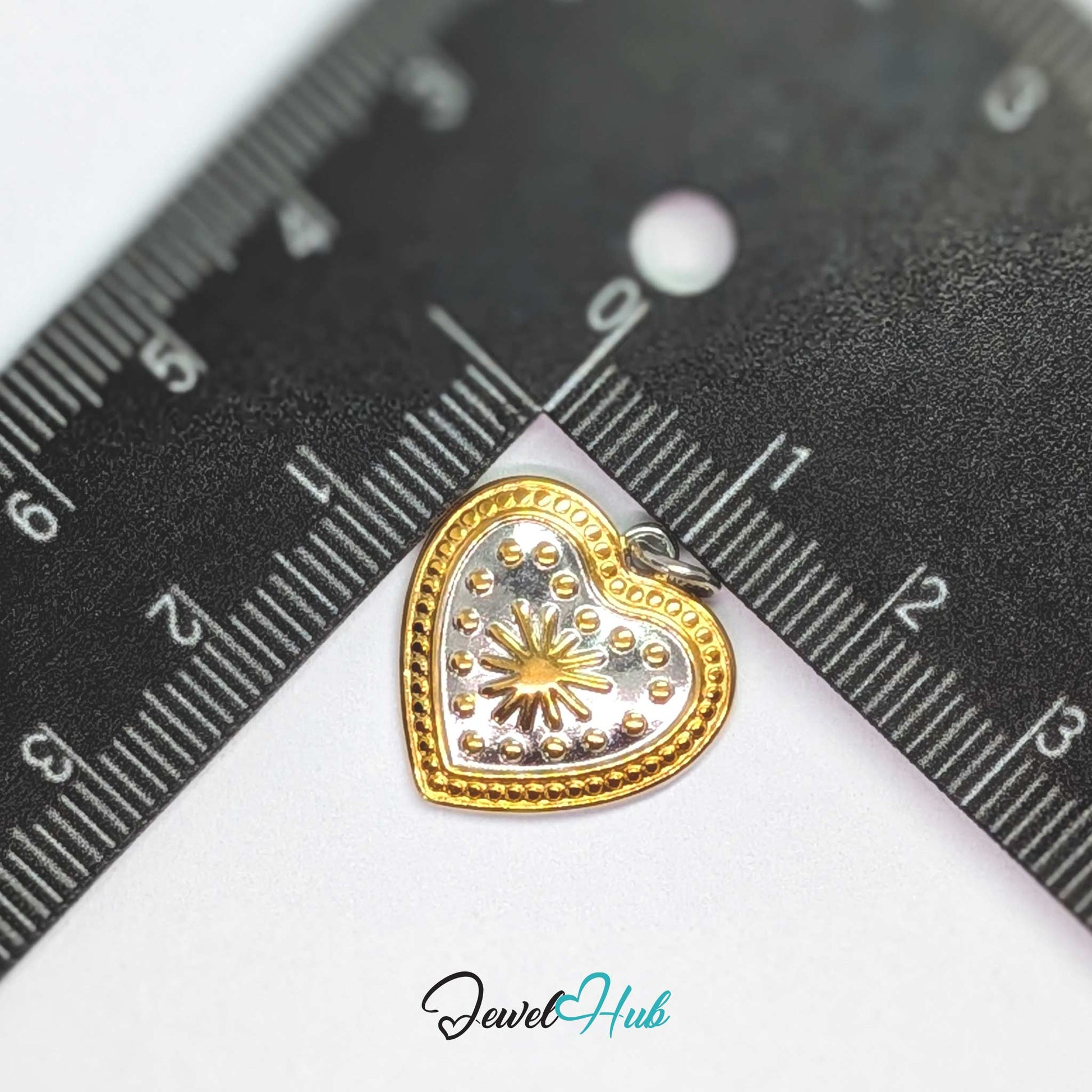 Starburst Heart charm, two-tone stainless steel, measured against a ruler at 19.5 x 19mm - JewelHub