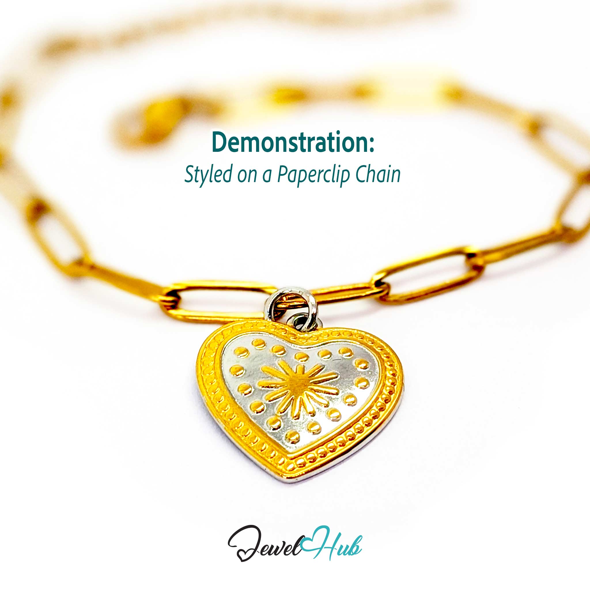 Starburst Heart charm, two-tone stainless steel, styled on a gold paperclip chain bracelet - JewelHub