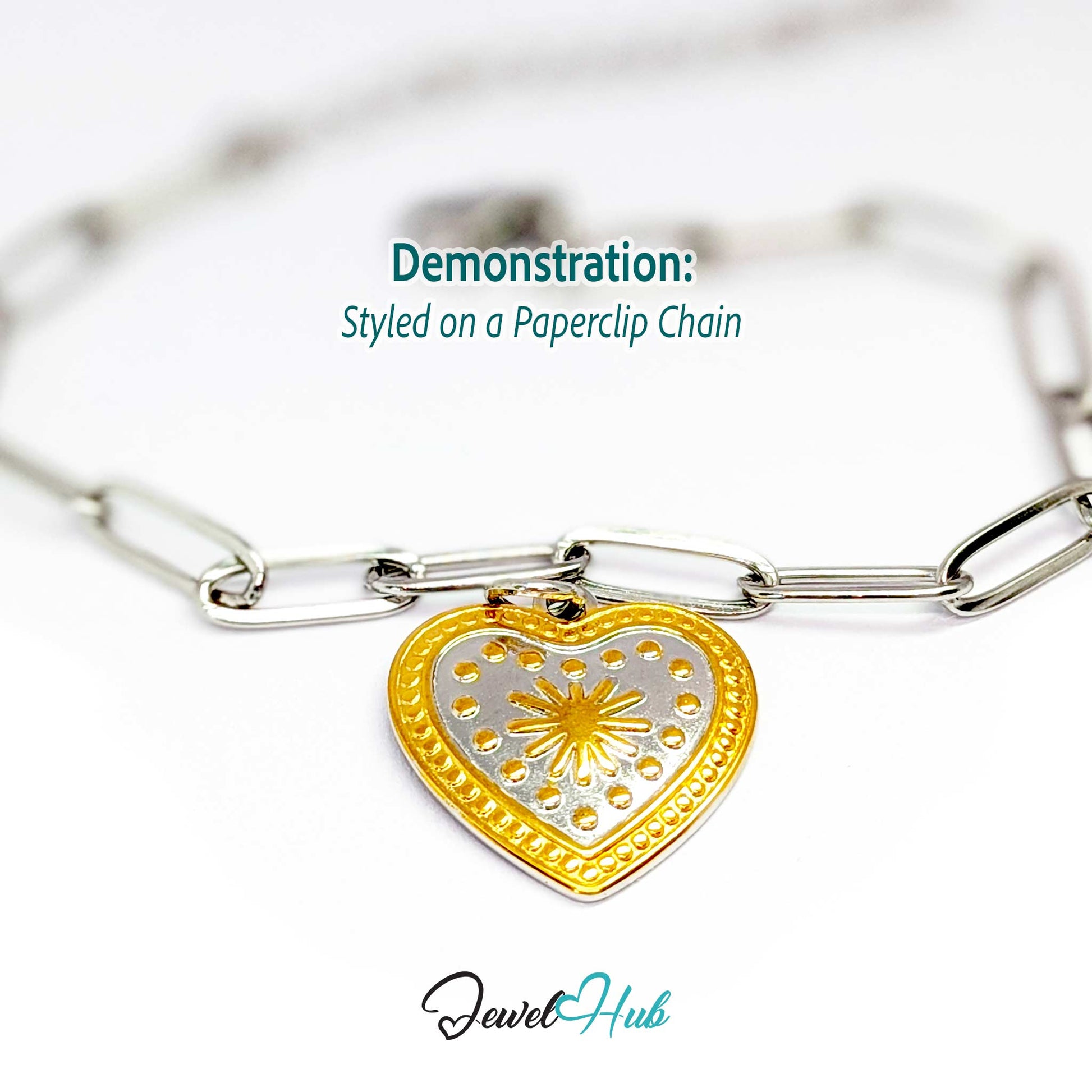 Starburst Heart charm, two-tone stainless steel, styled on a silver paperclip chain bracelet - JewelHub