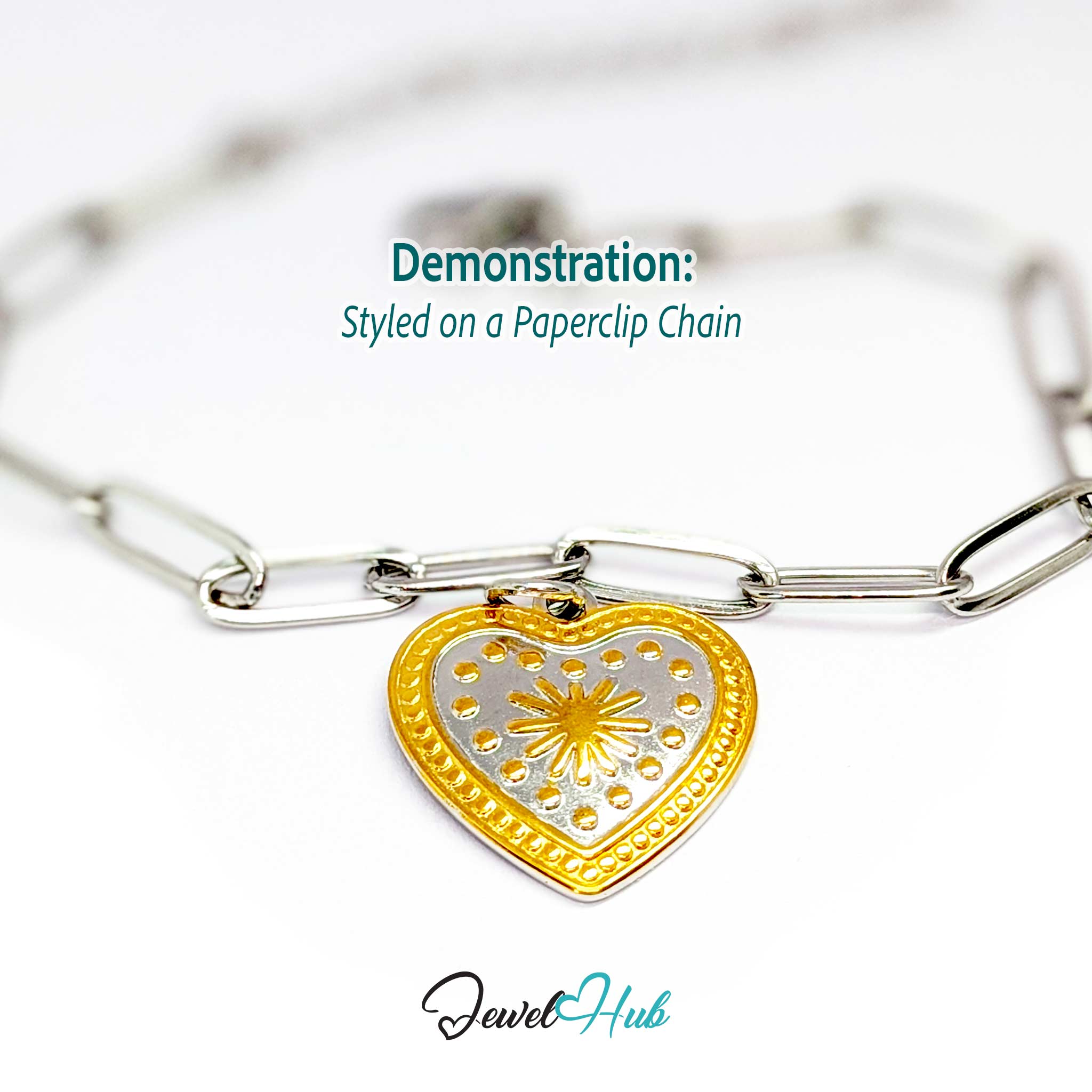 Starburst Heart charm, two-tone stainless steel, styled on a silver paperclip chain bracelet - JewelHub