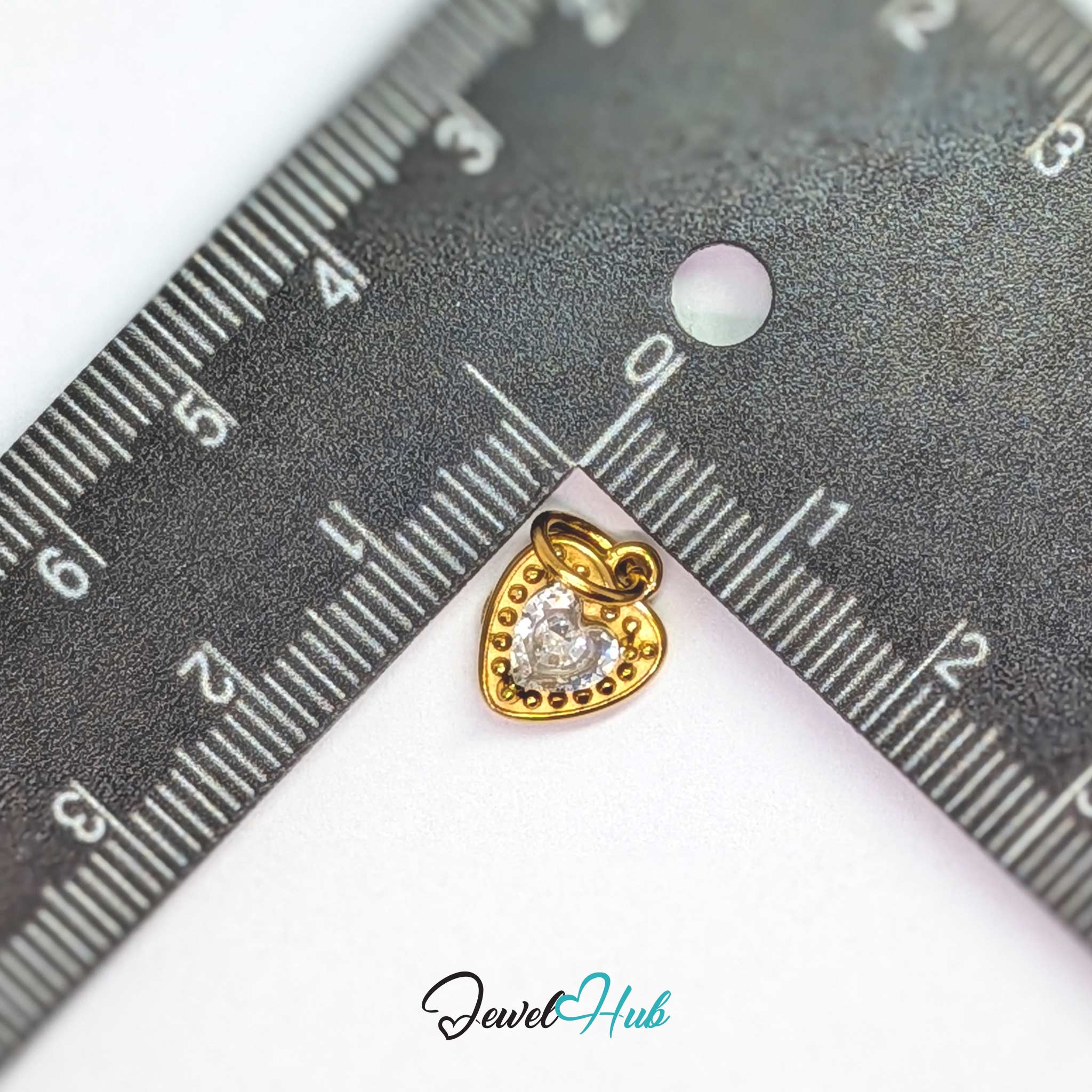 Gem Heart charm, gold stainless steel, measured against a ruler at 9.5 x 12mm - JewelHub