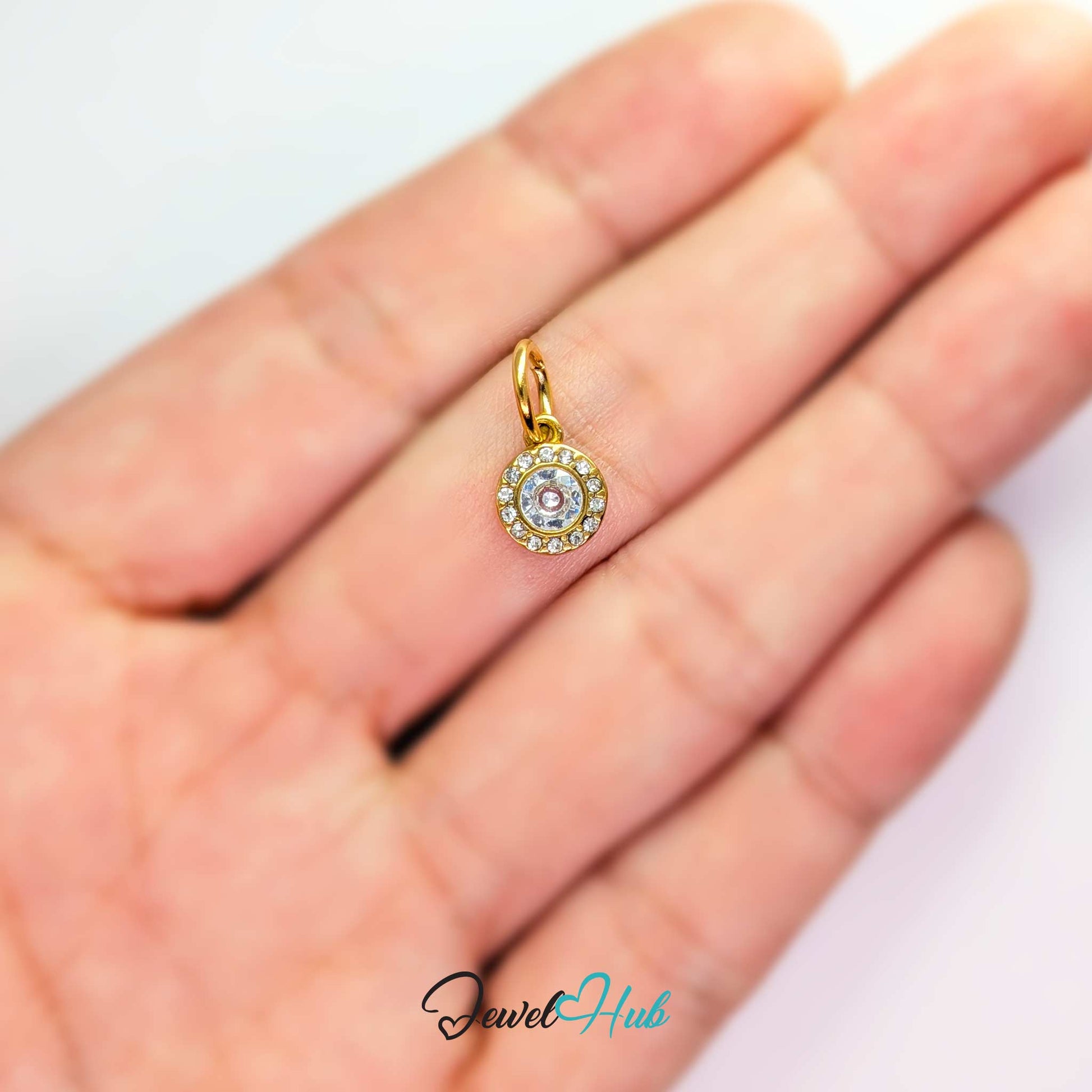 Halo Round charm, gold stainless steel, held in the hand to show its size - JewelHub